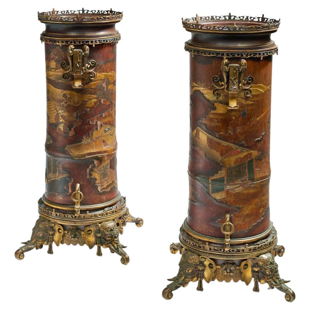 A 19th French century pair of Lacquered Bamboos Japonisme vases.

An amazing pair of tall cylindrical bamboo vases decorated in Japanese Gold and Sil-ver Hiramaki-E Lacquer with Pavilions in The Mist and Weaving Figures, Flown Over by a Pair of