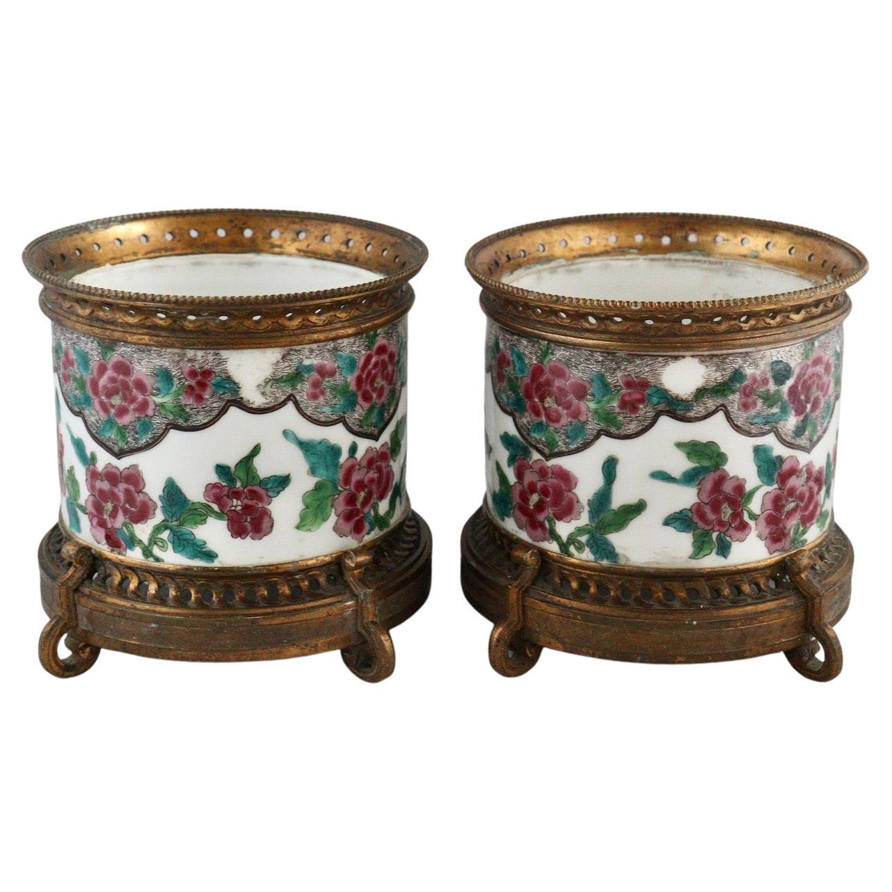 Pair of polychromed hand painted porcelain with Japonisme floral decoration
Ormolu-mounted with open-worked base and rim
Louis XVI Style
circa 1880.