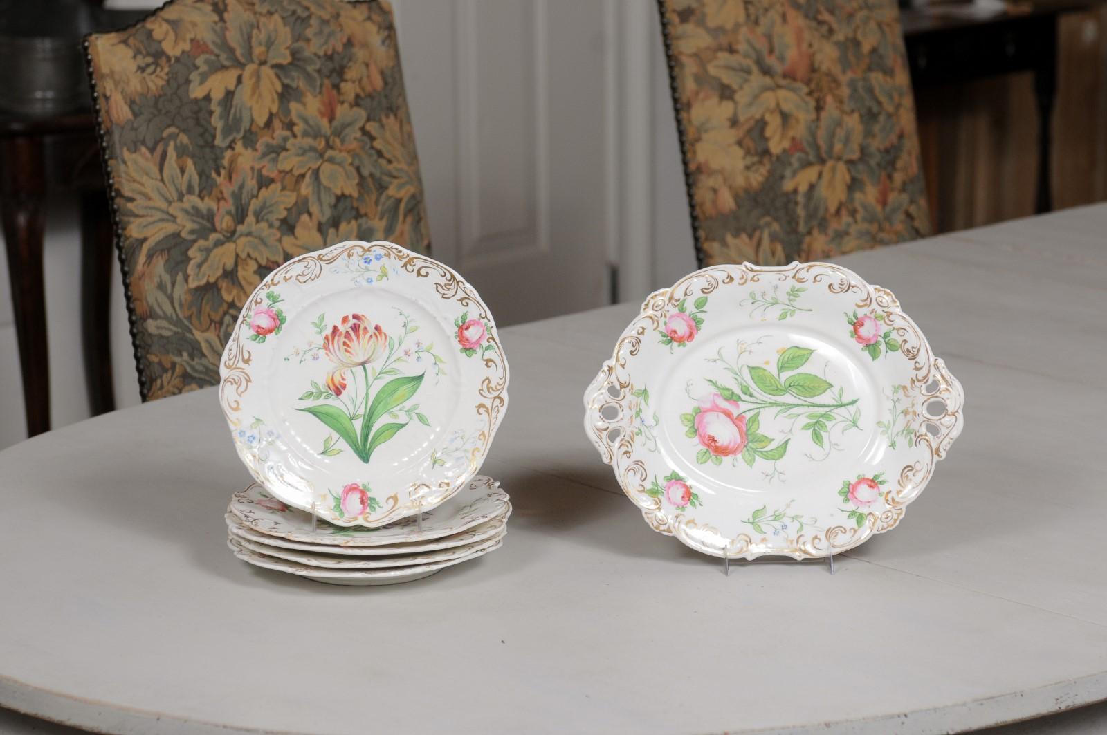A French Paris Porcelain dessert set from the 19th century, consisting of five dessert plates and a single compote, with pink roses décor. Created in France during the 19th century, this 'Porcelaine de Paris' dessert set immediately charms us with