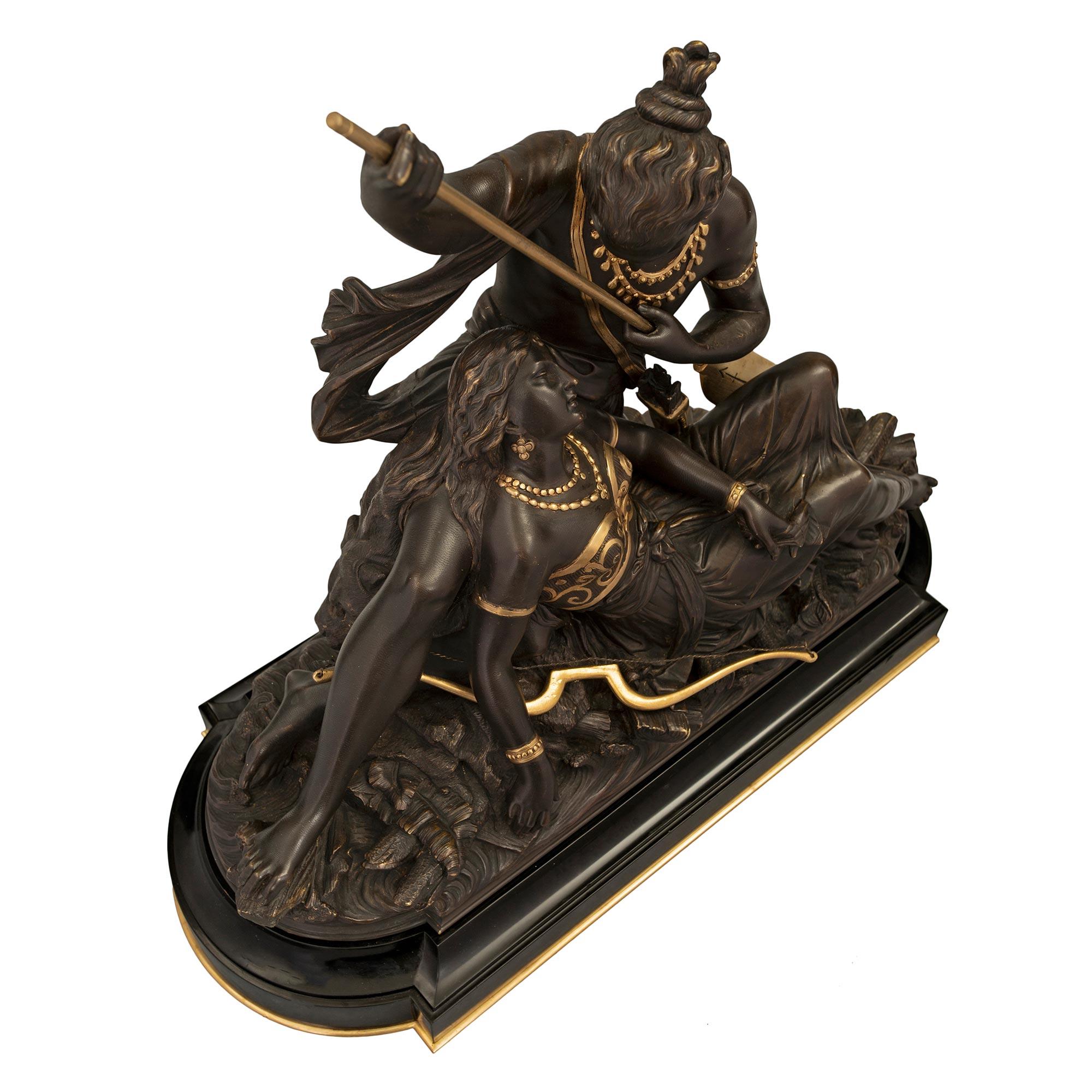 A sensational and high-quality French 19th-century patinated bronze and a gilt statue of native American lovers signed D. Marie. The bronze is raised on a black Belgium marble base, decorated by an ormolu bottom band and a concave mottled edge. The