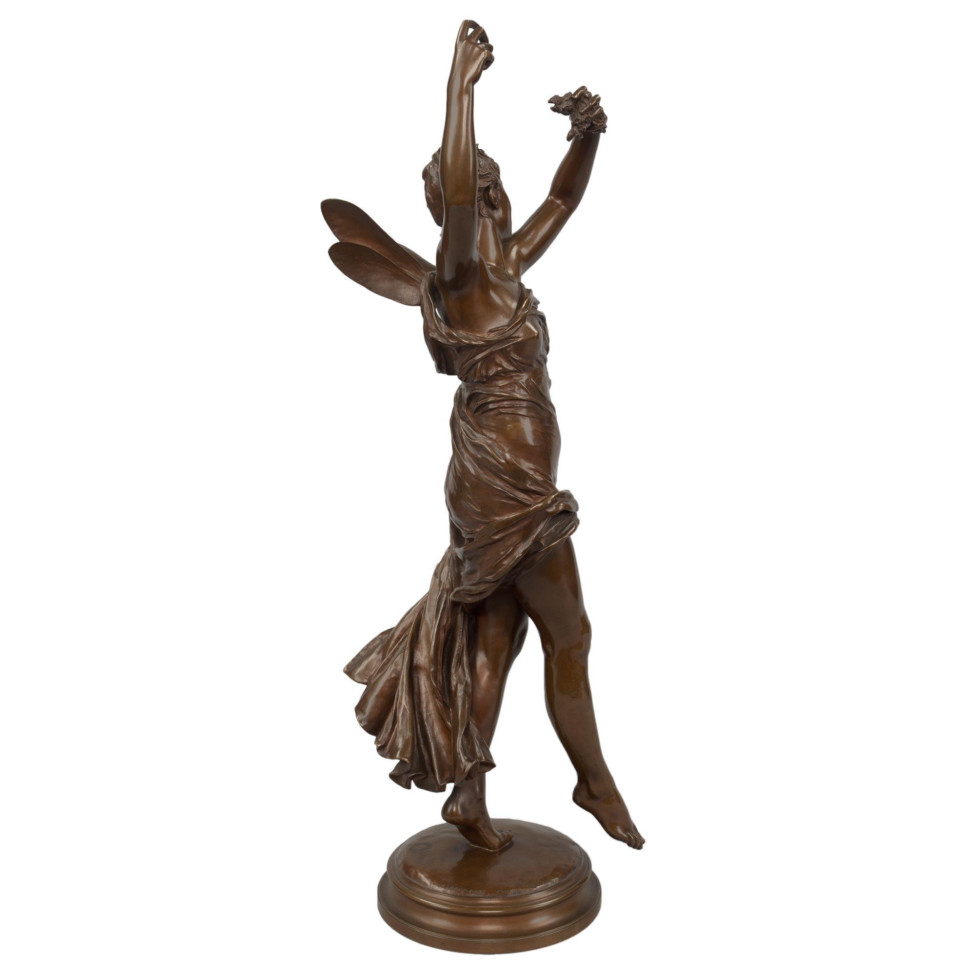 A sensational and very high quality French 19th century patinated bronze of a smiling Psyche signed by E. Delaplanche and cast by the renowned Barbedienne foundry. Psyche is raised by a mottled circular base. She is on her toes with one foot raised