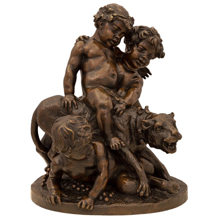 A charming and very high quality French 19th century patinated bronze statue. The statue is raised by an oblong shaped base with a wonderfully executed ground like design where three drunk Bacchanalian cherubs and a panther are playing amidst