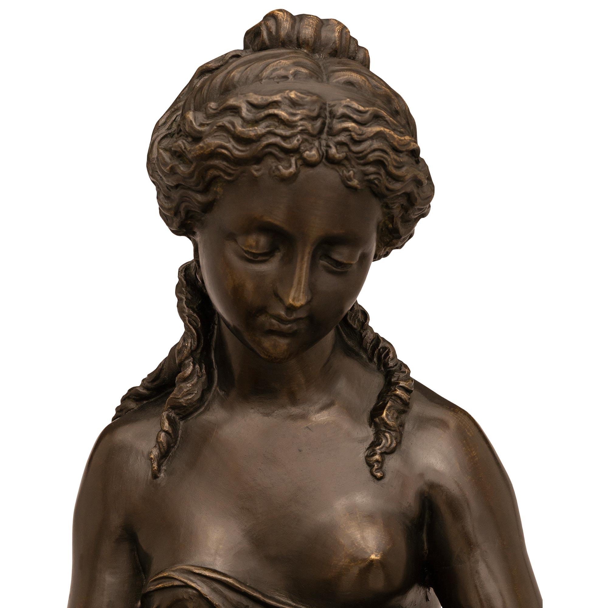 A wonderful and unique French 19th century patinated Bronze statue of a woman and child signed Stella. This finely detailed statue depicts a beautiful woman dressed in flowing garments while holding a scythe and rinsing the collected wheat with an