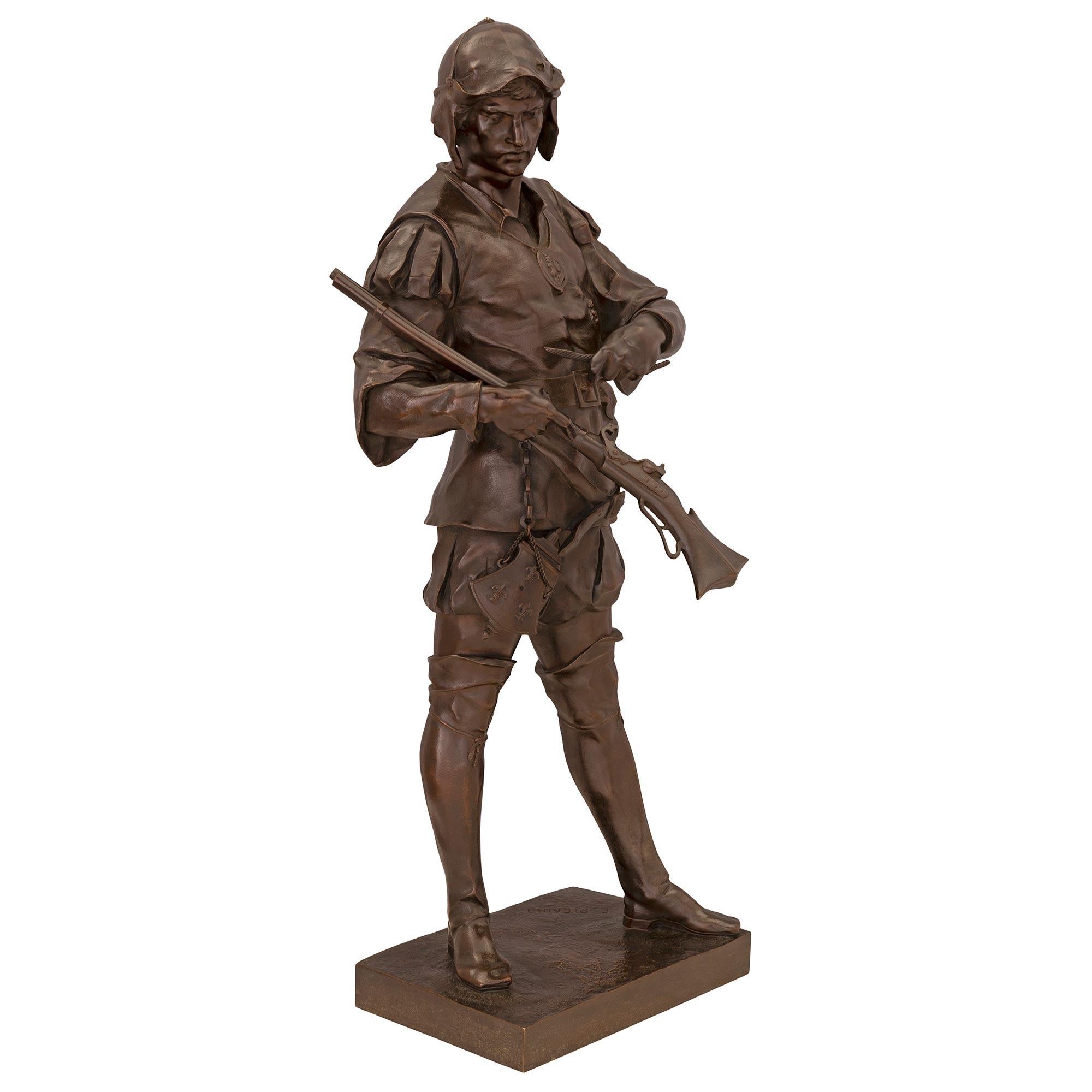 A striking and very high quality French 19th century patinated bronze statue of a young soldier, signed E. Picault. The large scale statue depicts a young soldier wearing high boots and his uniform, with a belt tied around his waist and a gunpowder