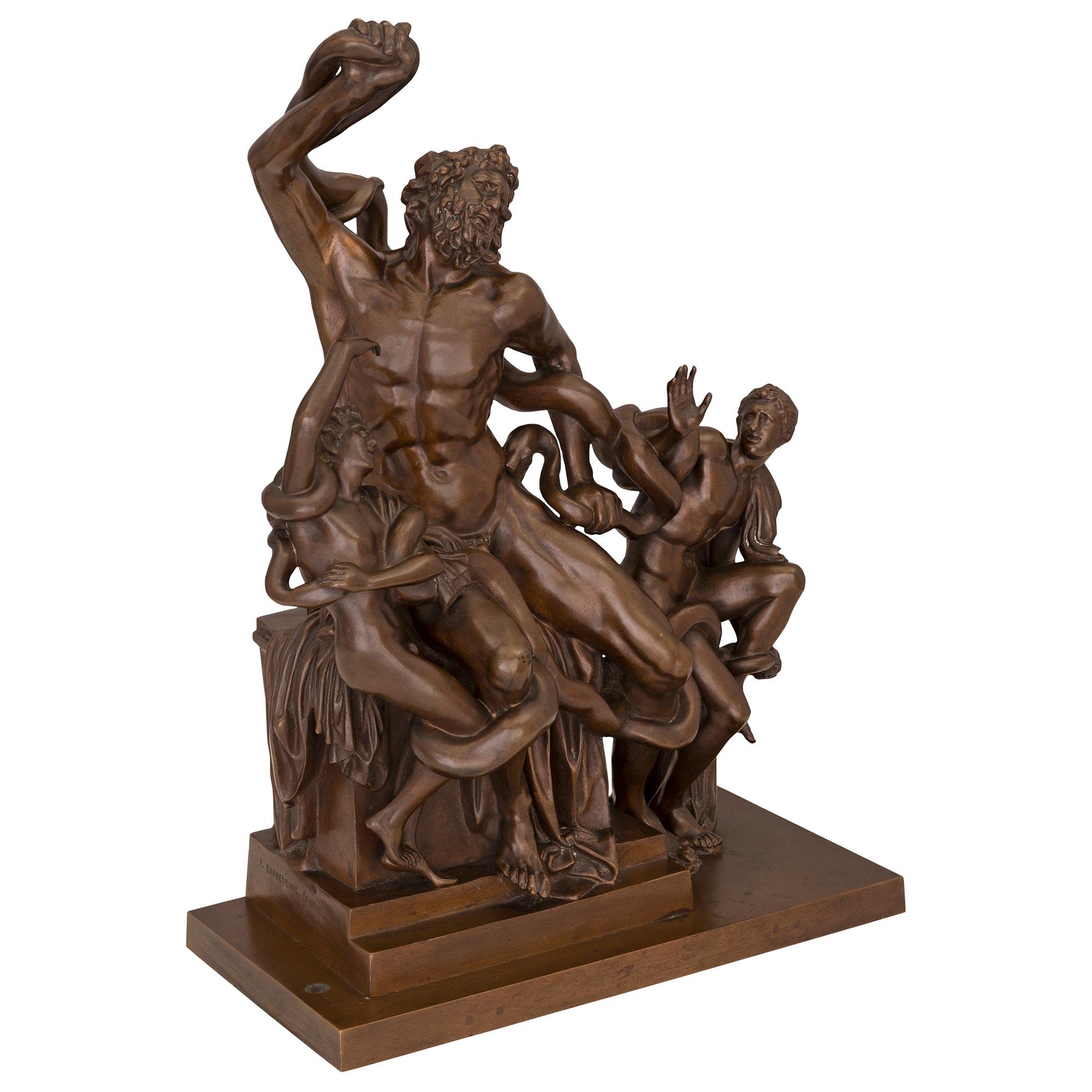 A most impressive and high quality French 19th century patinated bronze statue of Laocoön and his sons, signed Barbedienne. The bronze is raised by a rectangular base below a stepped pedestal support. At the center is the handsome and richly chased