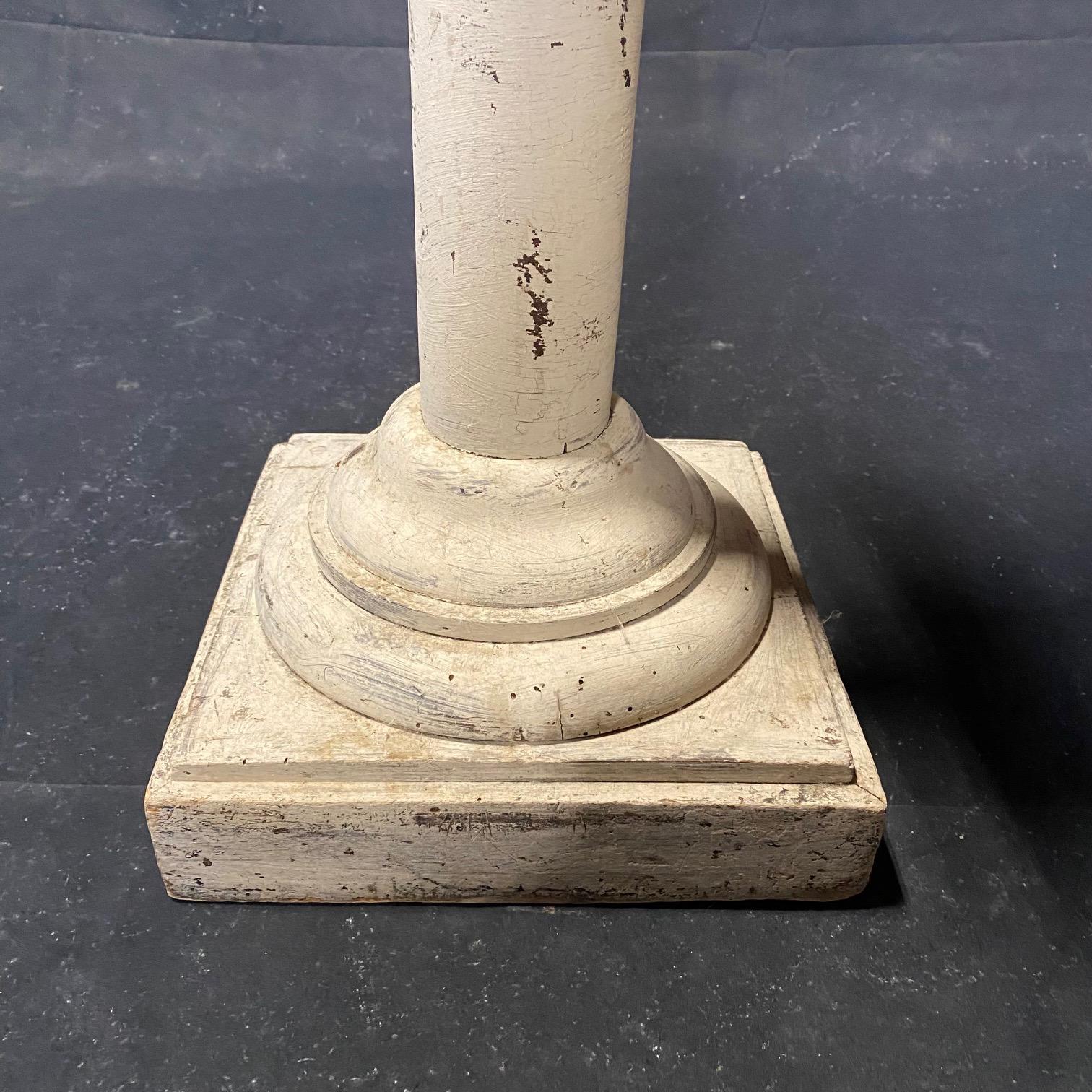 Bought in the South of France, this early wooden French pedestal column would serve as a focal piece or a plant stand. Retaining its early beigey ivory paint, this neutral pedestal column could serve a number of uses in any home decor. 
#6366

