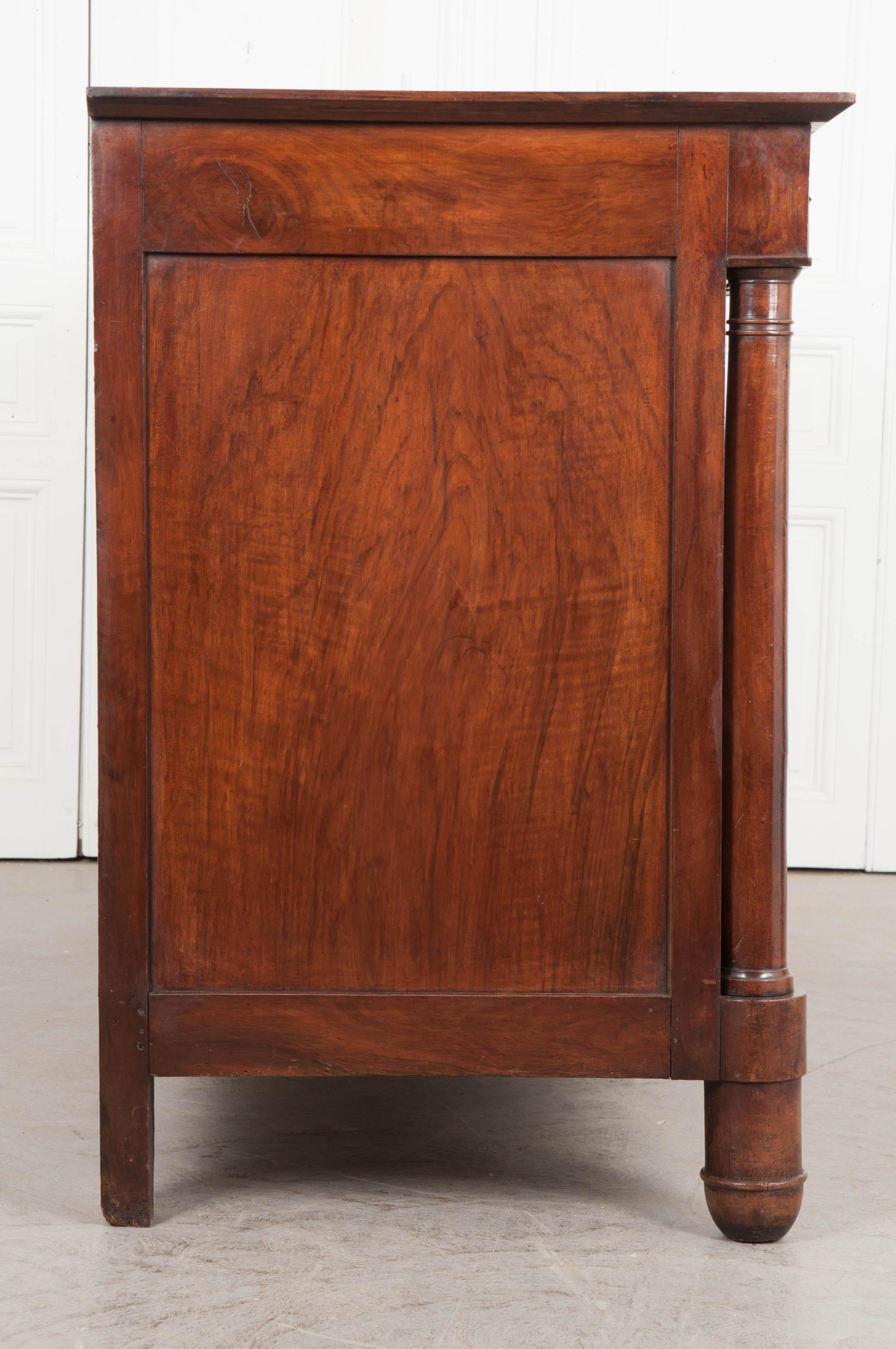 This generously proportioned enfilade was made in France, circa 1810. The thick gray marble top is in wonderful antique condition and has a few pink veins that can be found throughout. Two wide drawers are situated in the buffet’s apron. They are