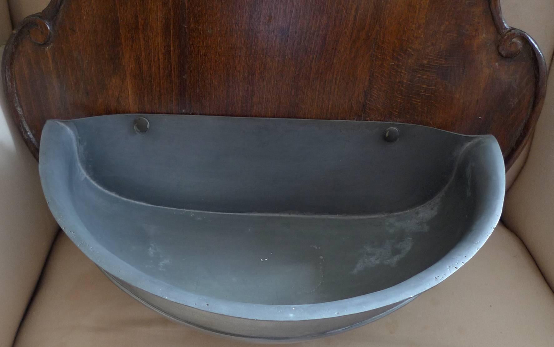 French 19th century Pewter Lava Beau on a stained mahogany base with one tap.