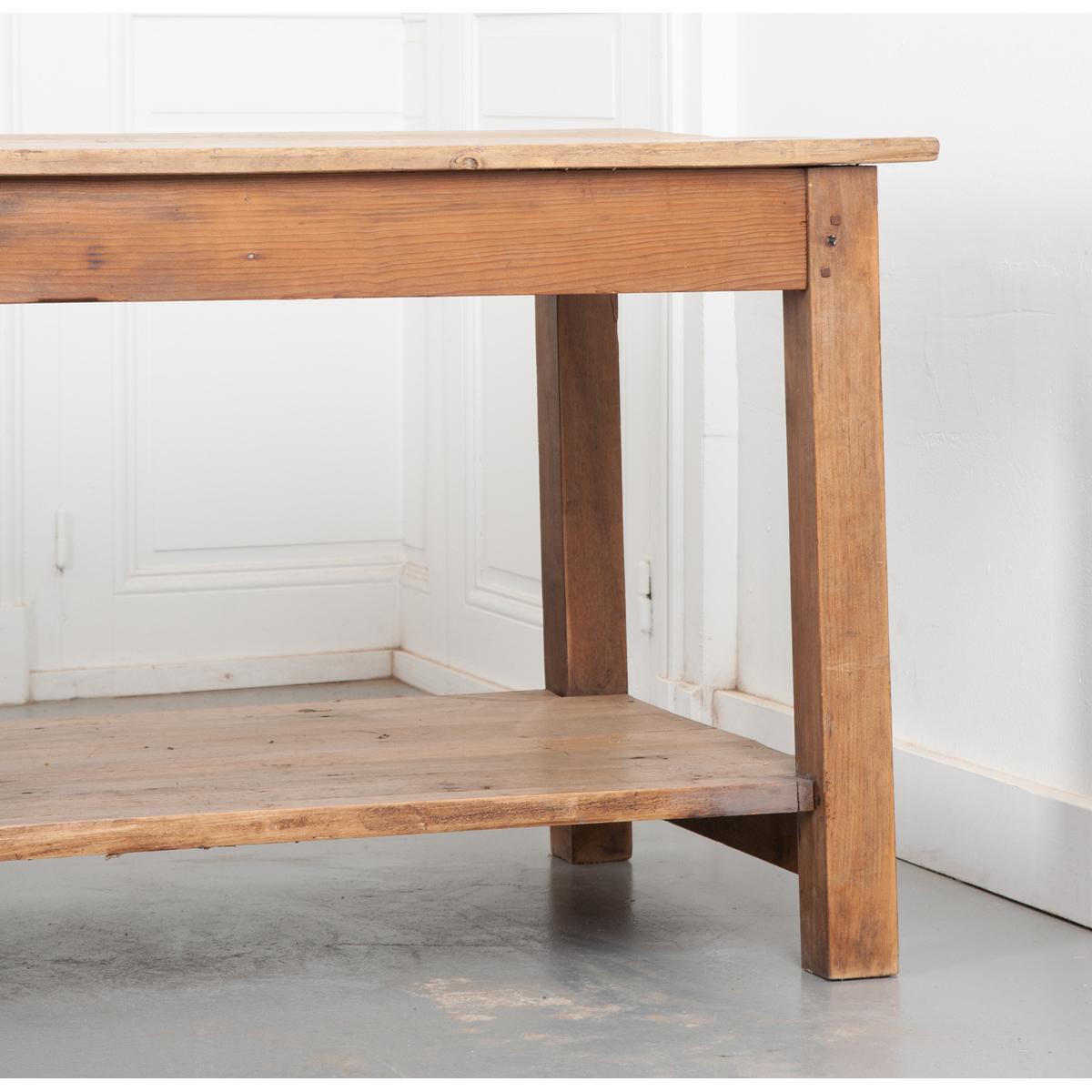This exceptionally constructed 19th century French drapers table is over 11 feet long! Made from solid oak and pine. The work surface is made from three boards that bear the marks of many years of life that give it a great patina. The whole is