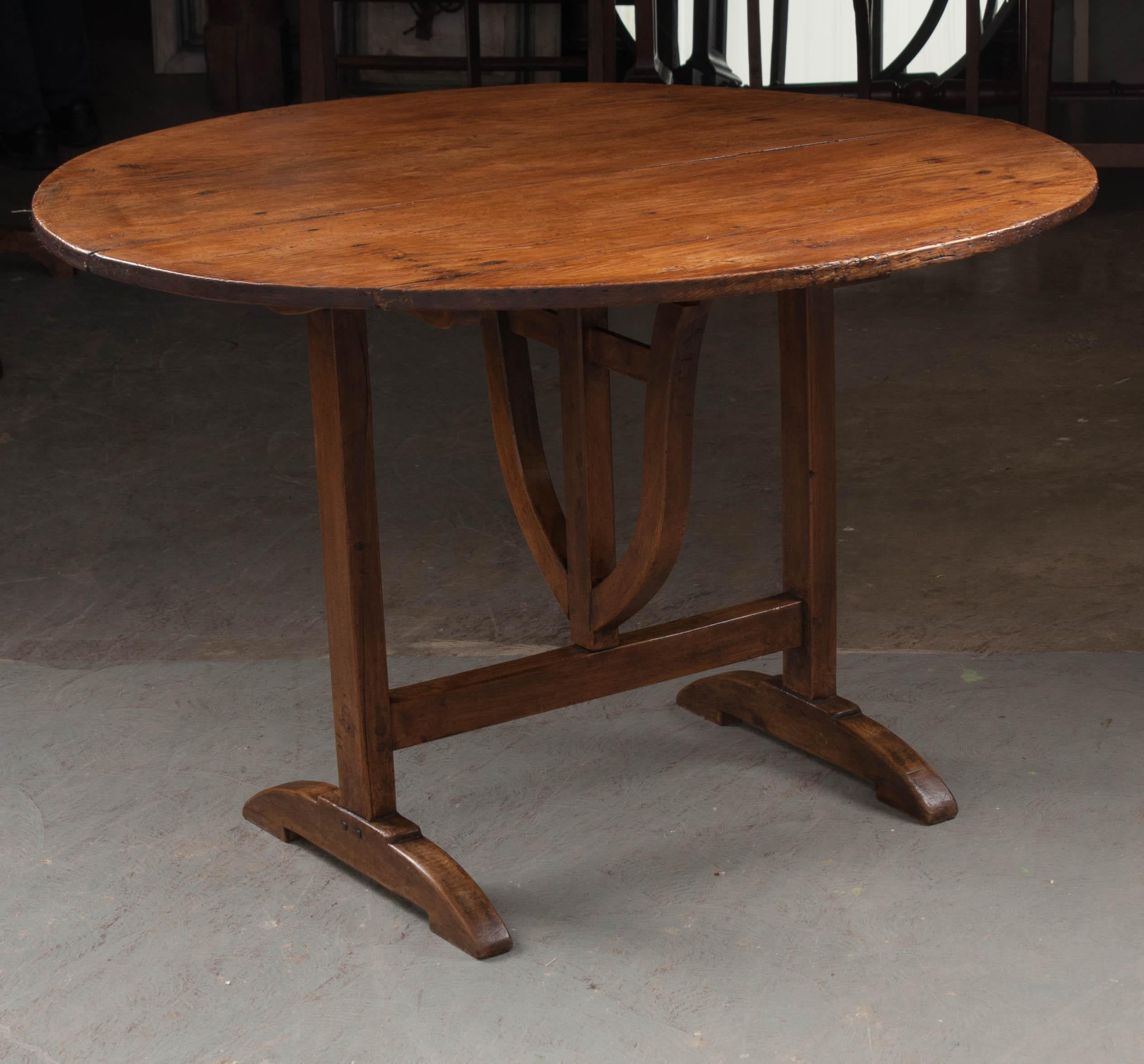 A very special pine and walnut vendange table, also known as a wine taster’s table, made in France, circa 1870. The table has a round top, made of pine, while the styled base is made of walnut. This table would have been brought out for tasting wine