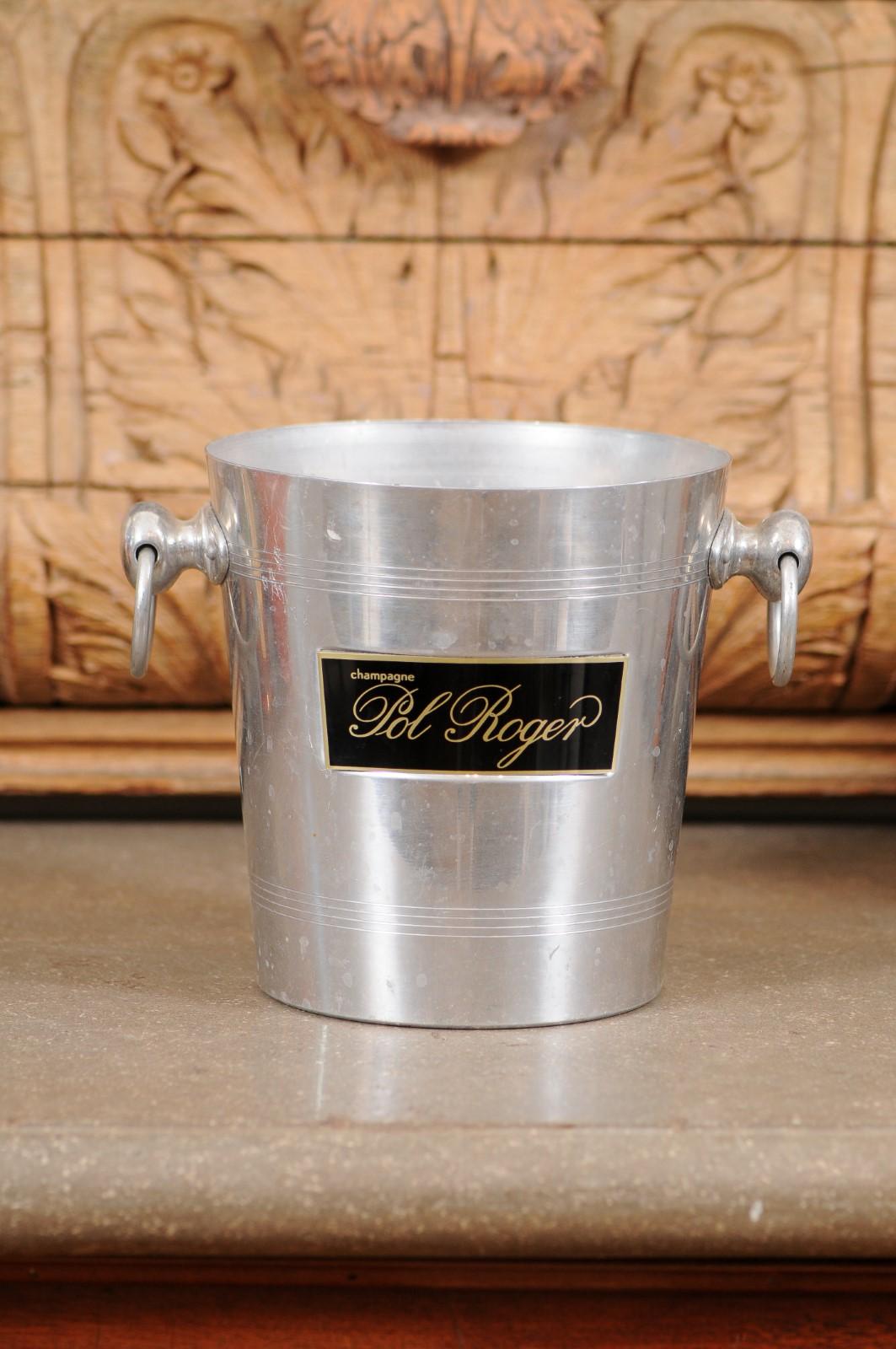 A French Pol Roger champagne bucket from the 19th century, with black and gold label and lateral handles. Created in France during the 19th century, this metal bucket showcases two lateral handles flanking a simple tapering body. Presenting a
