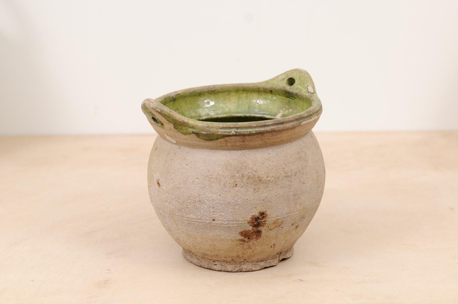 A French Provincial pottery hanging container from the 19th century, with green glazed interior. Created in Southern France during the 19th century, this hanging container captures our attention with its generous unglazed lines showing nice aging,