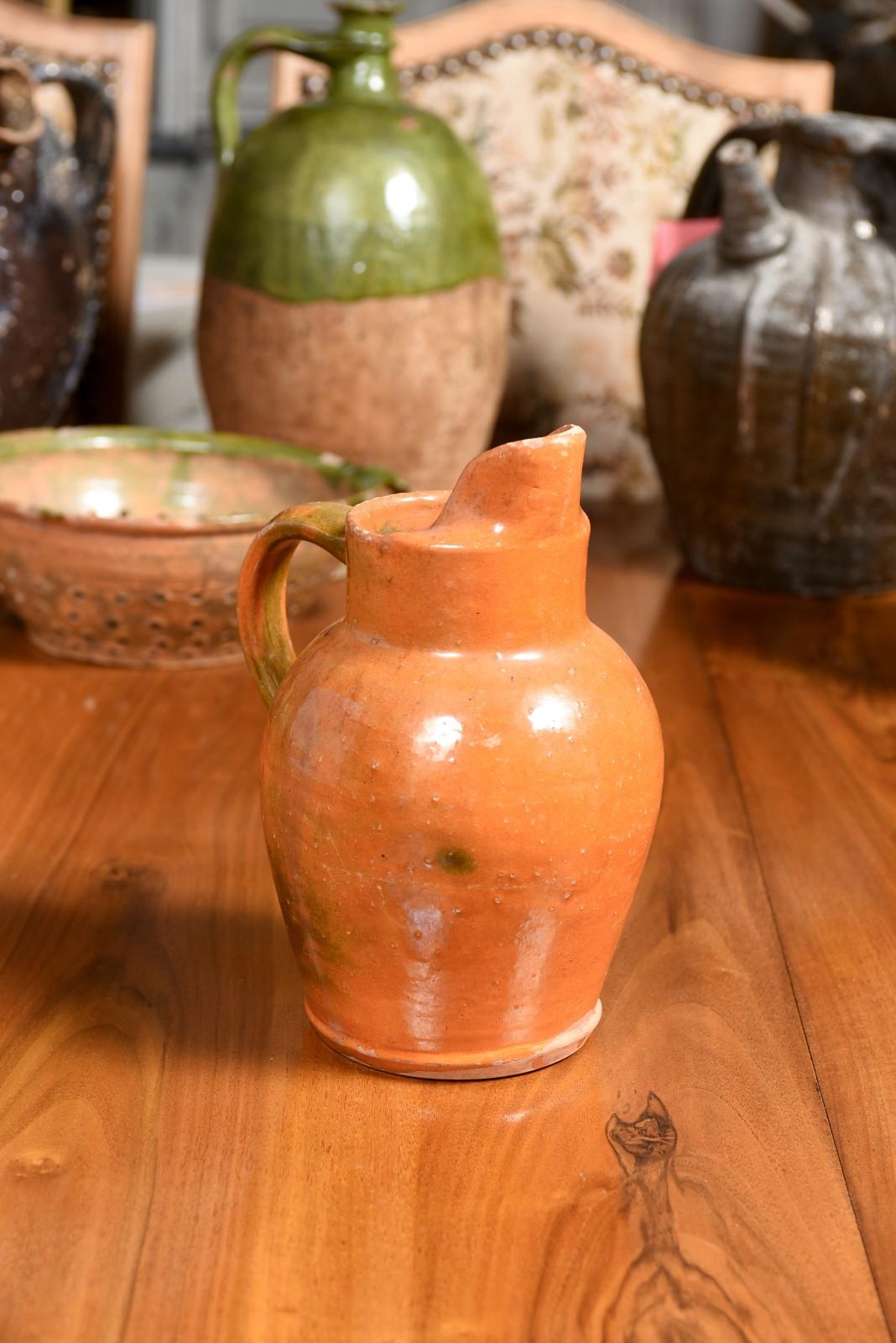 Glazed French 19th Century Pottery Jug with Orange Glaze, Back Handle and Front Spout