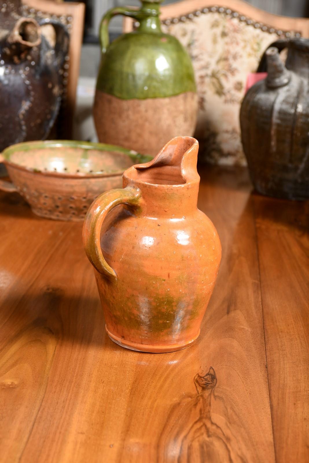 French 19th Century Pottery Jug with Orange Glaze, Back Handle and Front Spout 1