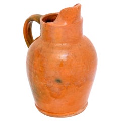 Pichet en poterie française du 19ème siècle avec glaçure orange, poignée arrière et cuillère avant
