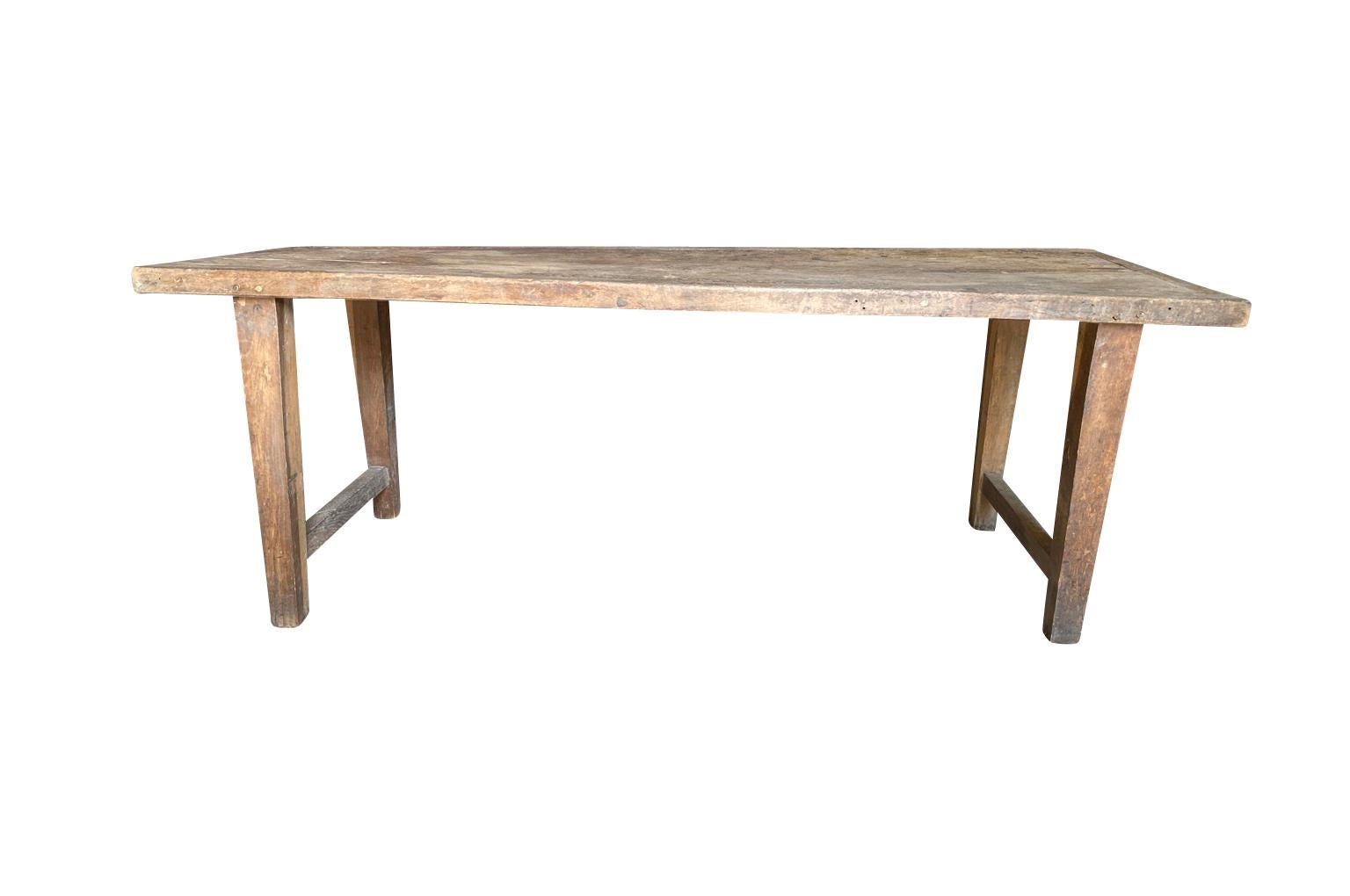 A very handsome later 19th century French primitive work table - Farm Table in oak. Minimalist lines lend this table a very contemporary feel. Lovely patina. Wonderful as a dining table or console as well.