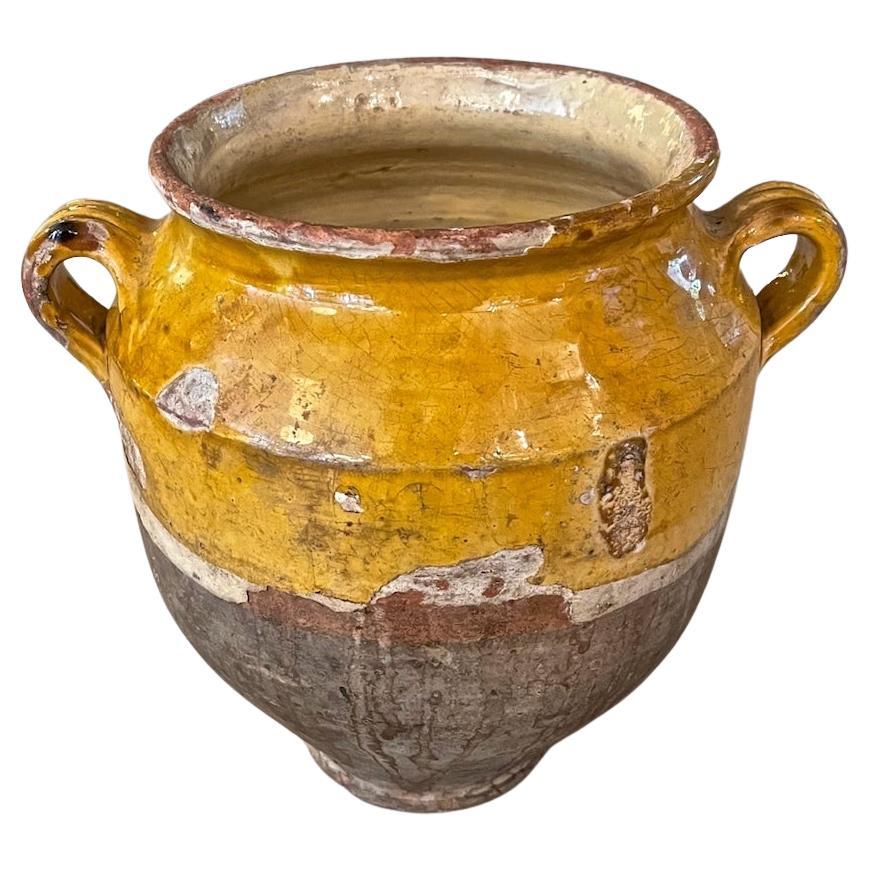 This is a fine example of a 19th Century French terracotta confit pot. These pots were used for preserving food in the 19th Century; mainly meats in fat, such as duck confit. The word 'confit' comes from the French verb 'confire' which means to