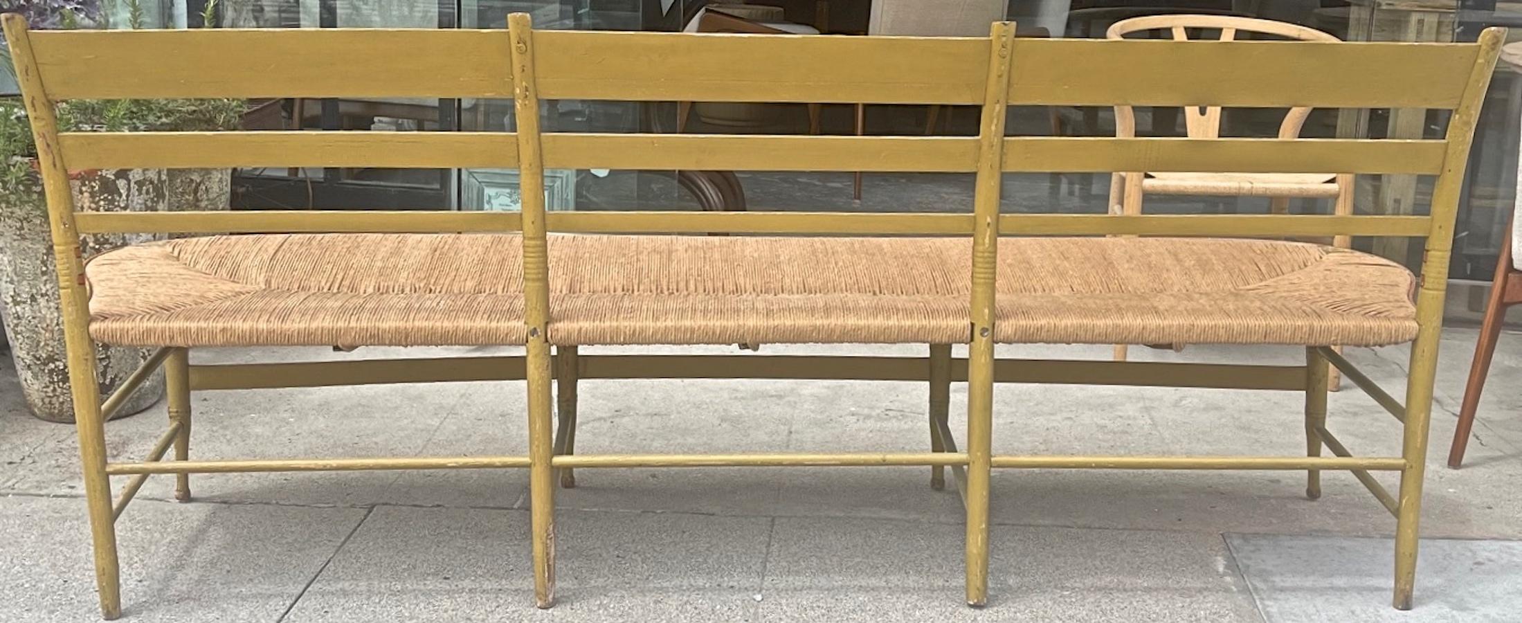 This is a fine example of a typical 3 seat rush bench from the 19th Century from the Provençe area of Southern France. The paint work is original and the rush has been newly rewoven.
