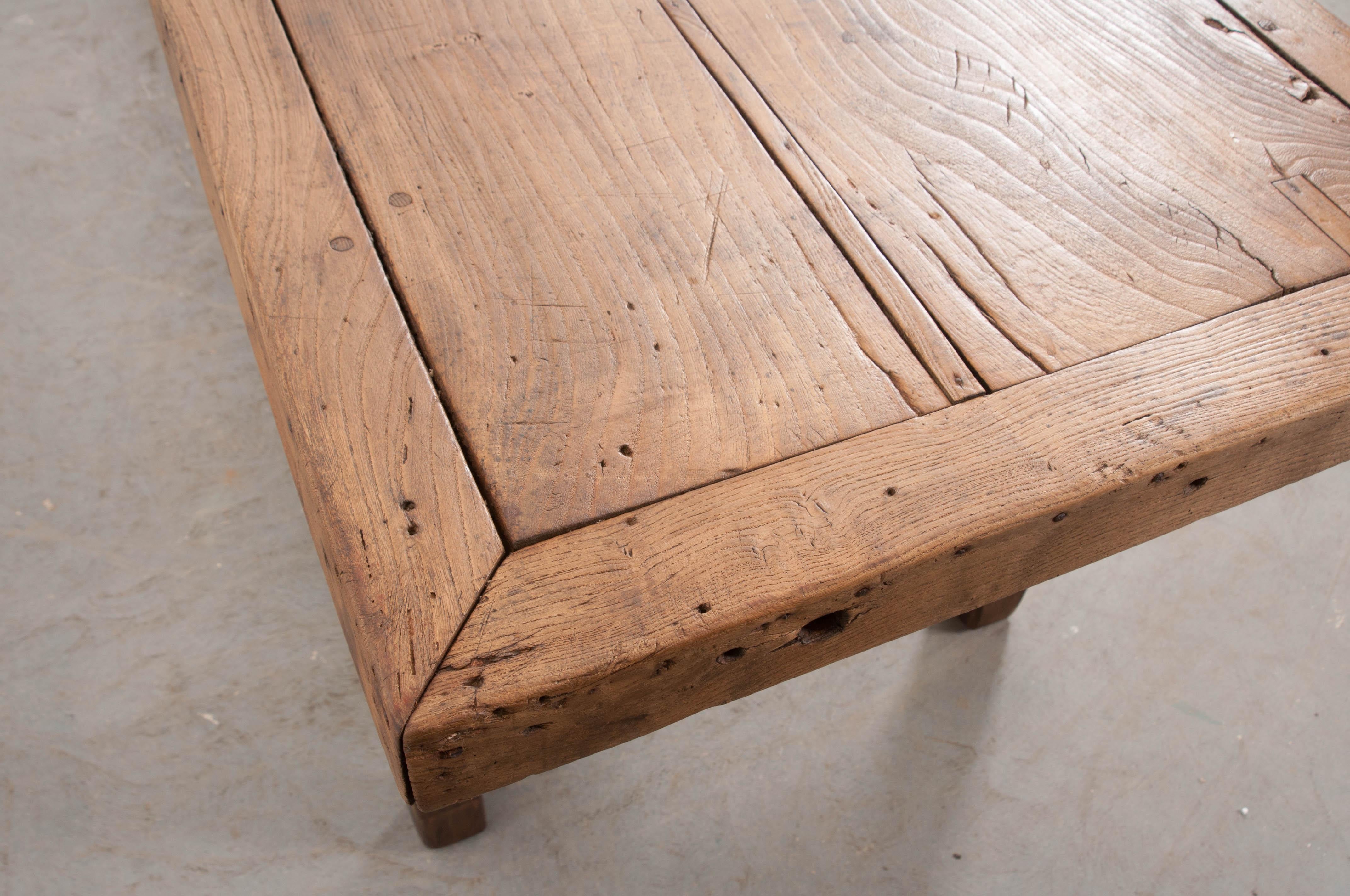 This handsome oak farmhouse trestle table, constructed with mortise-and-tenon joinery, is from the French countryside, circa 1860s. The table’s surface, made of a single, thick oak plank surrounded by a mitered oak frame, is supported on bracketed