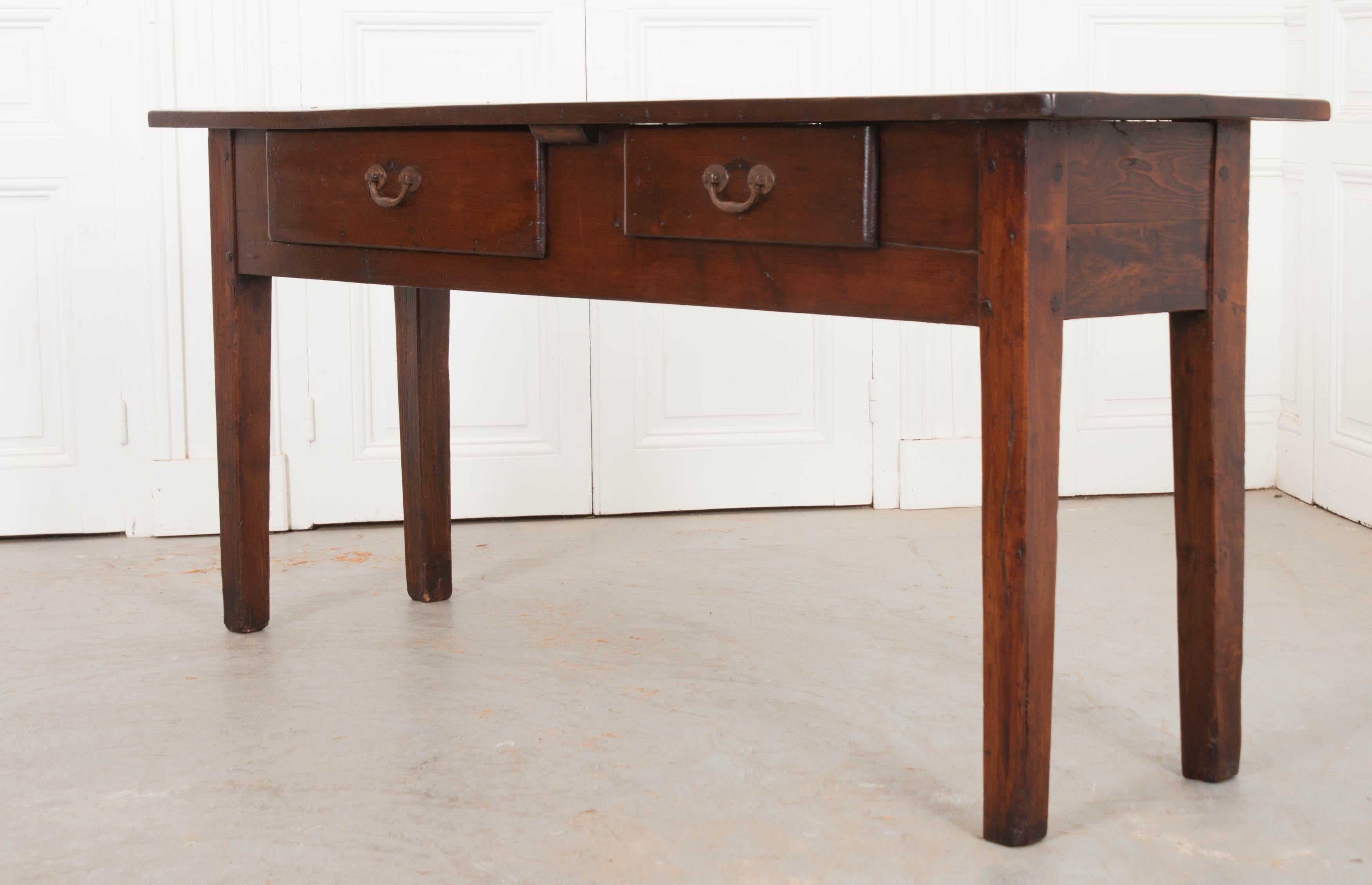 This handsome Provincial oak server, circa 1830s, is from France and has developed a beautiful patina over time. Of pegged construction, the two-plank surface rests upon an apron outfitted with two dove-tailed drawers, one large drawer ideal for