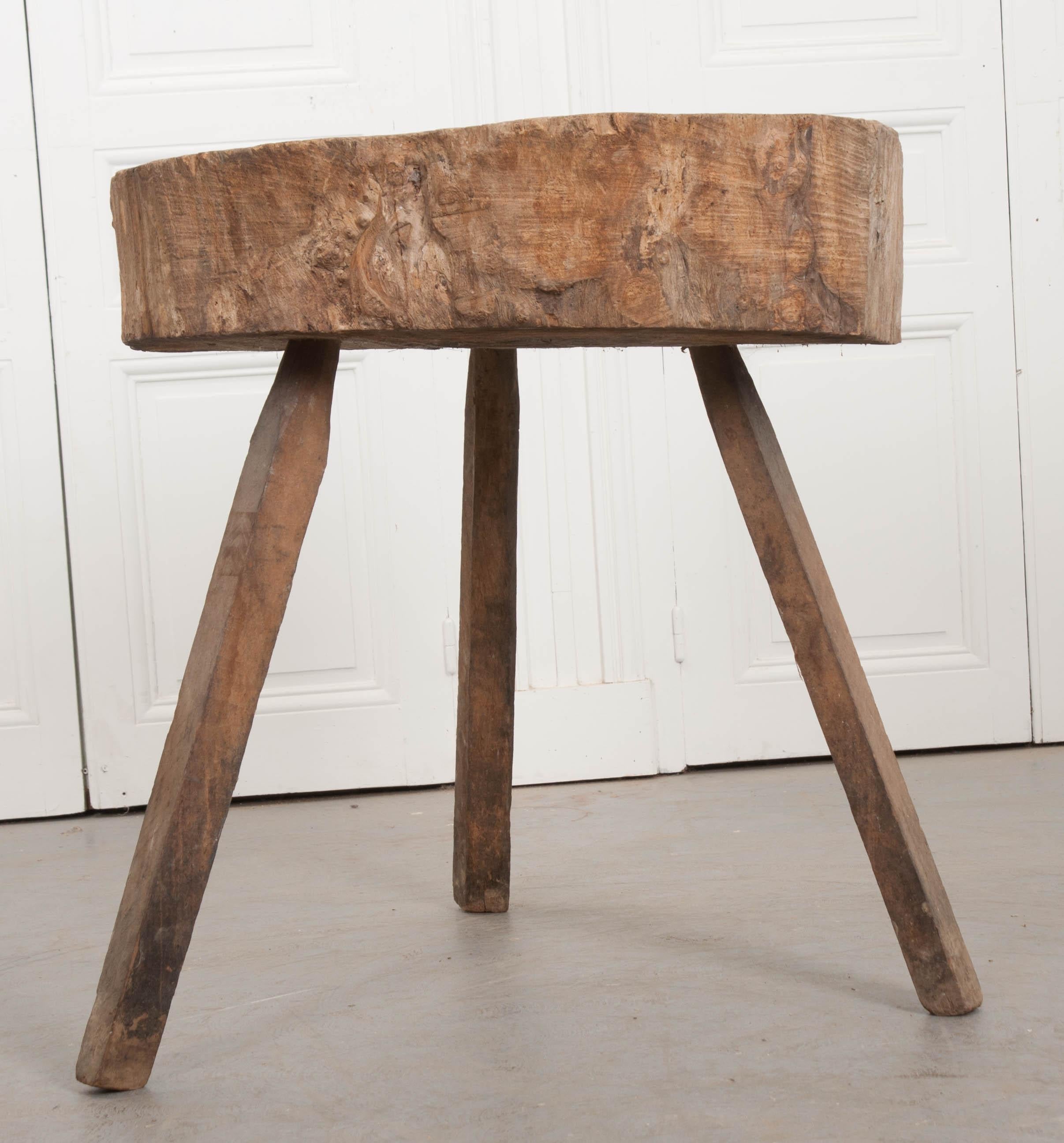 An impressive circular chopping block straight from the bucolic countryside of France! It is sectioned from an 8? slab of tree trunk and supported by three simply-planed splayed legs, circa 1880s.