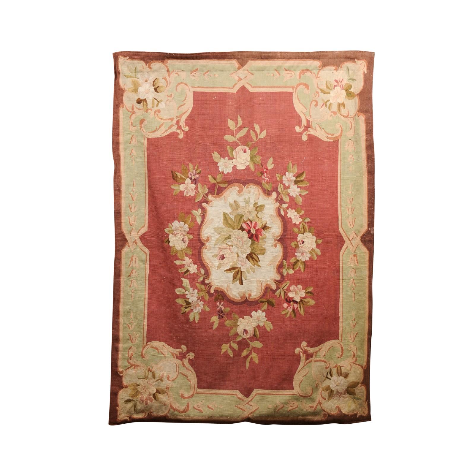 A French Royal Manufacture of Aubusson woven tapestry from the 19th century, with floral motifs and red, light green and brown tones. Created during the 19th century in the Aubusson manufacture located in central France, this wall tapestry features