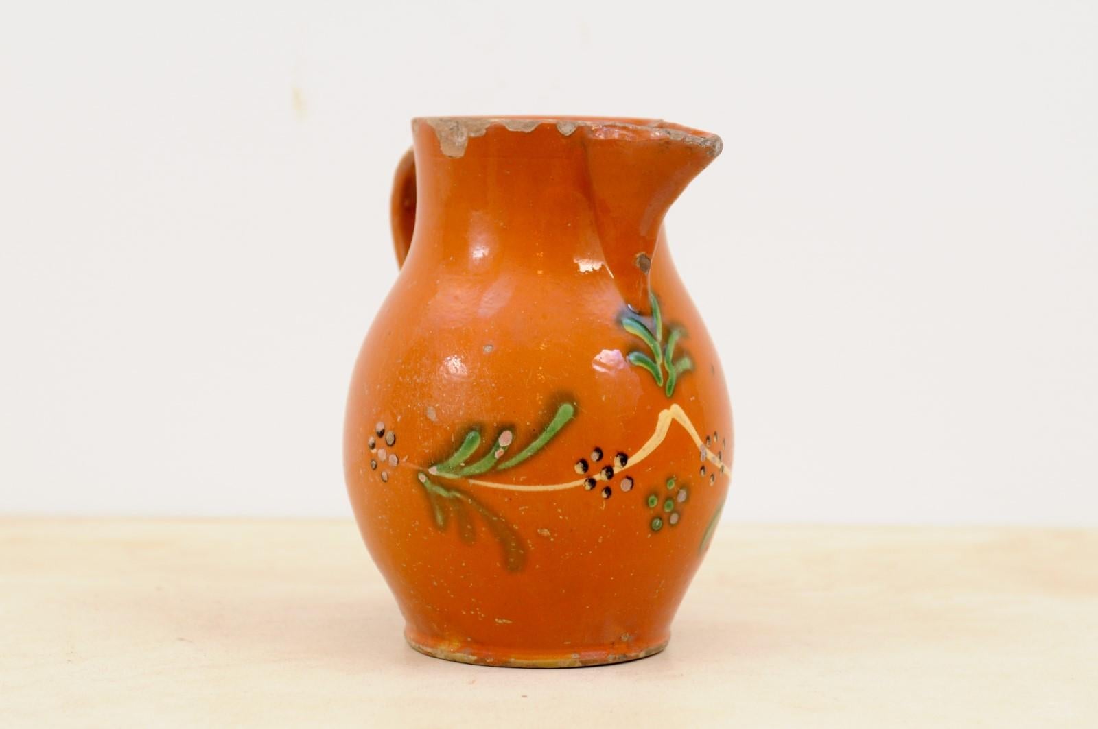 Rustic French 19th Century Redware Floral Pitcher with Orange, Cream and Green Glaze For Sale