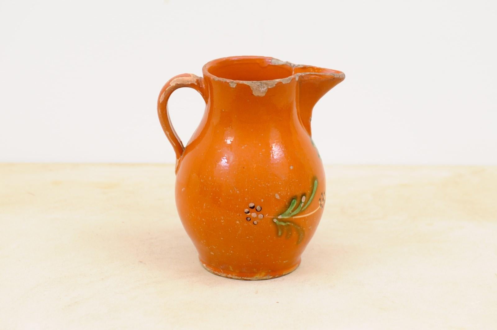 Glazed French 19th Century Redware Floral Pitcher with Orange, Cream and Green Glaze For Sale
