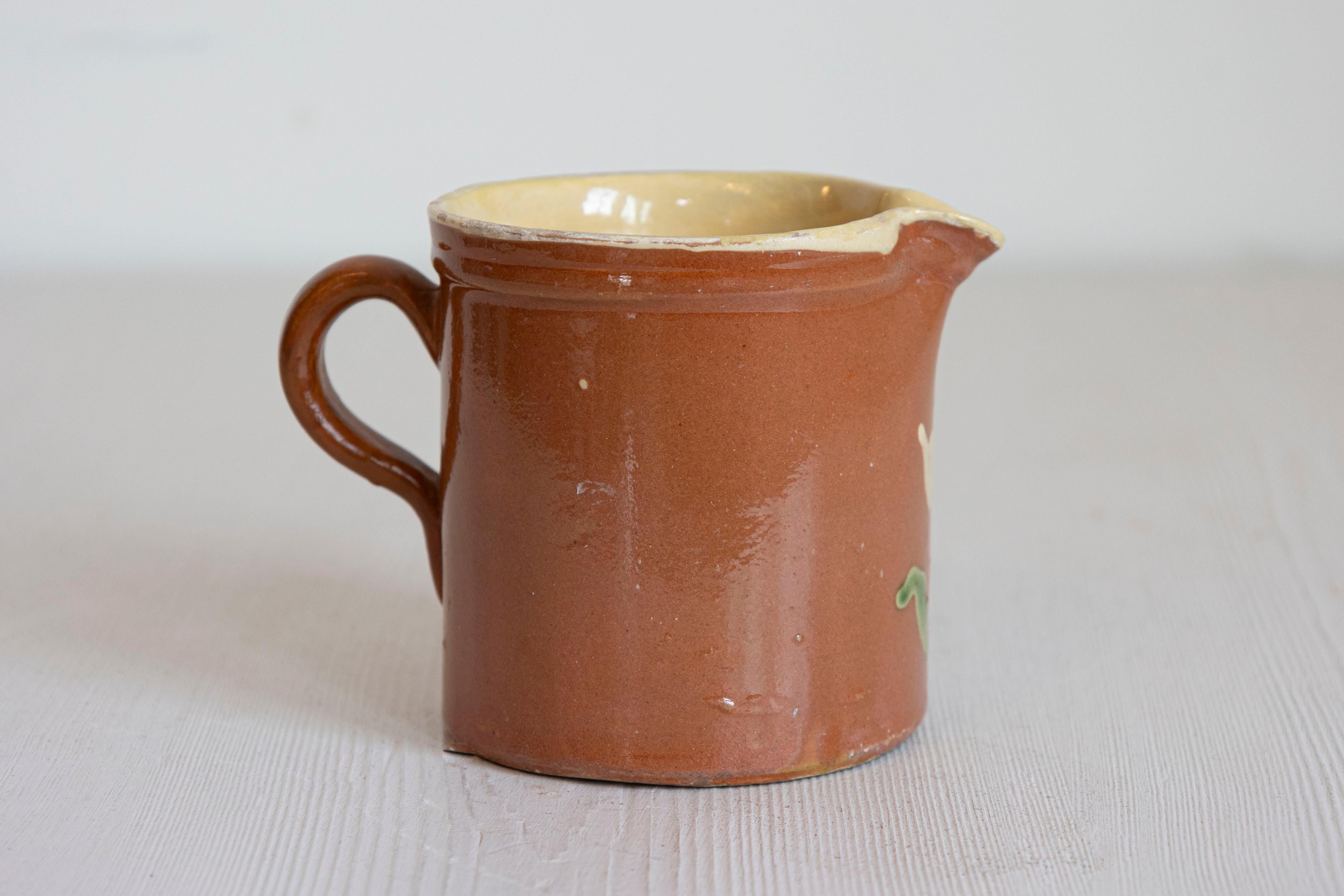 Glazed French 19th Century Redware Pitcher with White Flower Decor For Sale