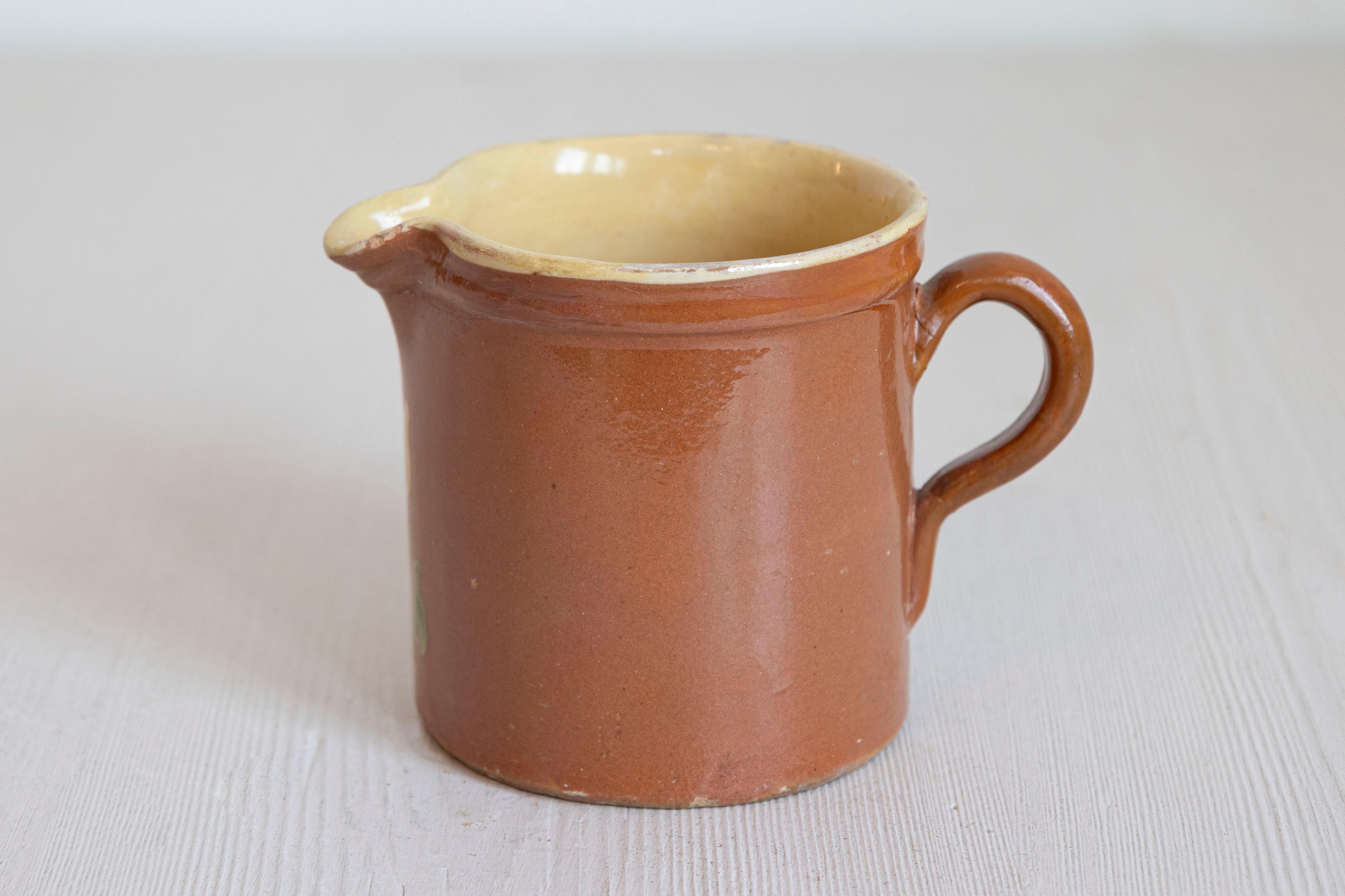 Pottery French 19th Century Redware Pitcher with White Flower Decor For Sale