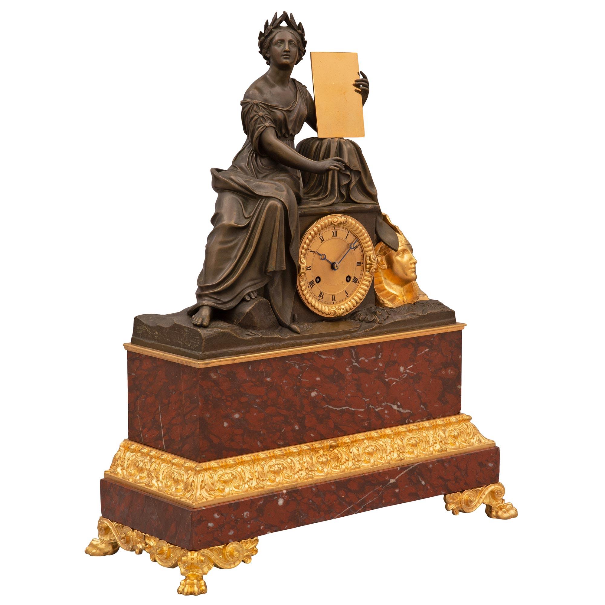 A striking and very high quality French 19th century Renaissance st. Rouge Griotte marble, patinated bronze, and ormolu garniture clock set. The clock at the center is raised by handsome lions paw feet amidst fine scrolled movements. The rectangular