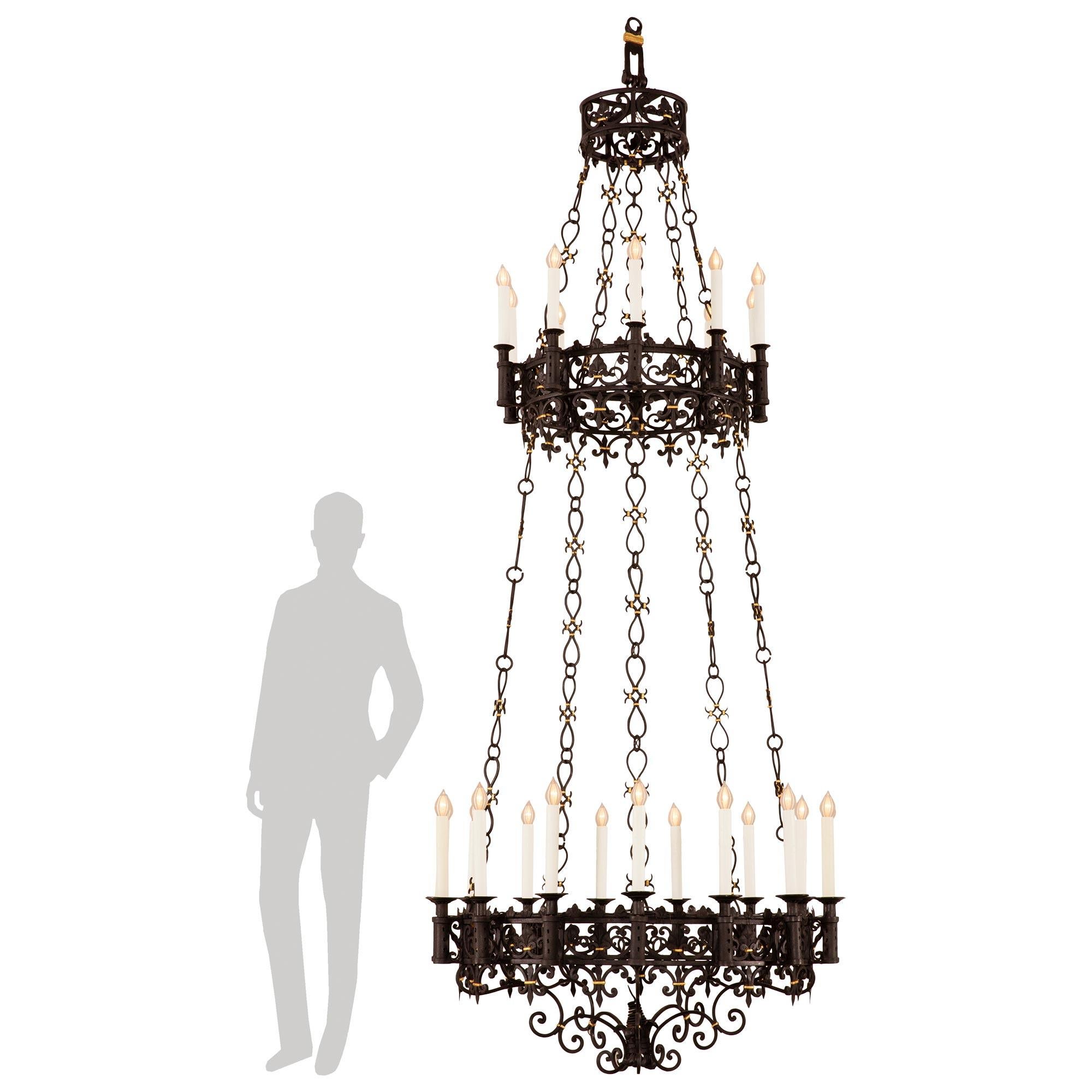 An impressive and large scale French 19th century Renaissance st. Gilt and Wrought Iron chandelier. This palatially scaled twenty-five light chandelier is centered by an array of 'C' scrolled Wrought Iron bands that surround the scrolling acanthus