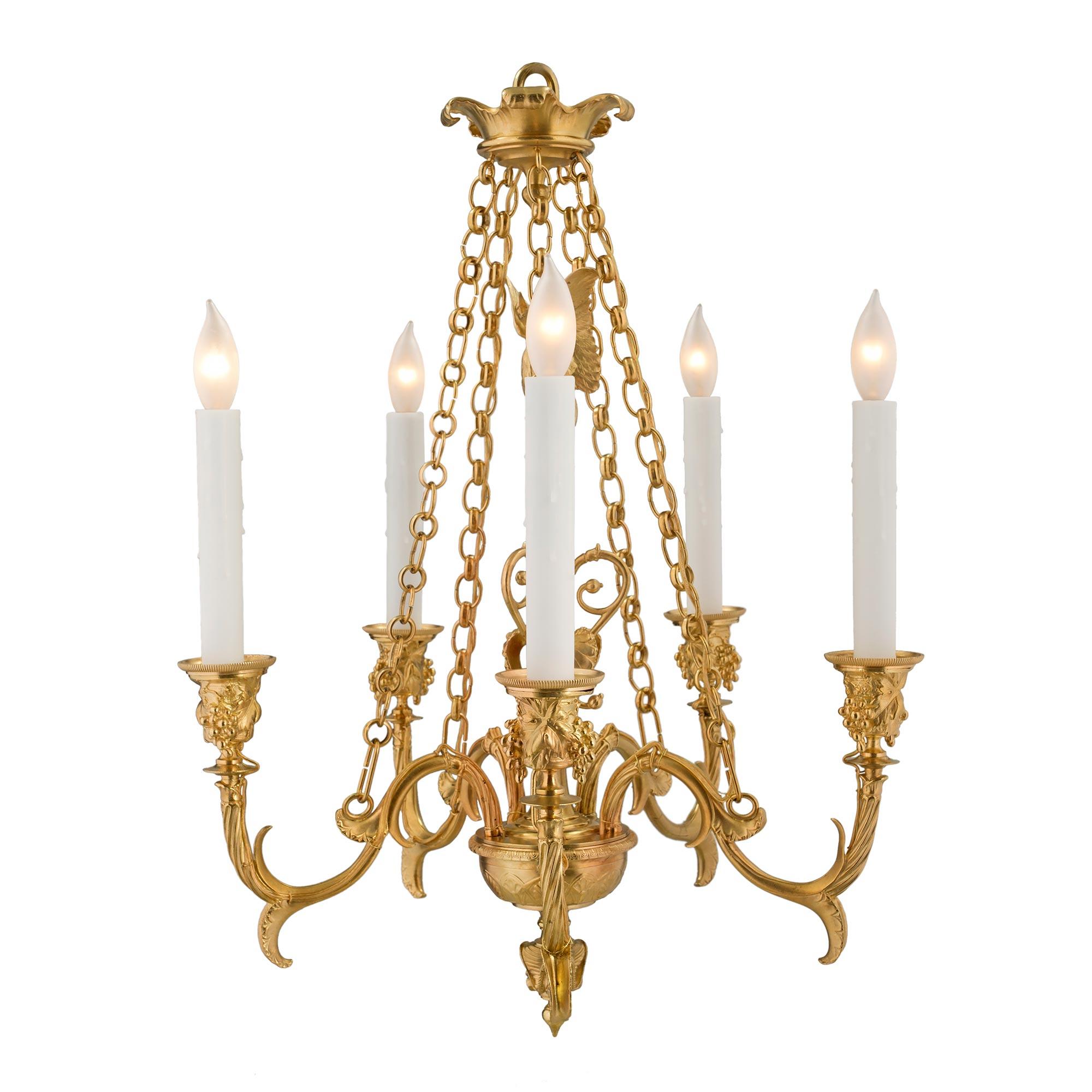 An elegant and high quality French 19th century Renaissance St. ormolu five-arm chandelier possibly by F. Barbedienne. The chandelier is centered by a most unique bottom finial with richly chased faces below beautiful interlocking palmettes designs.