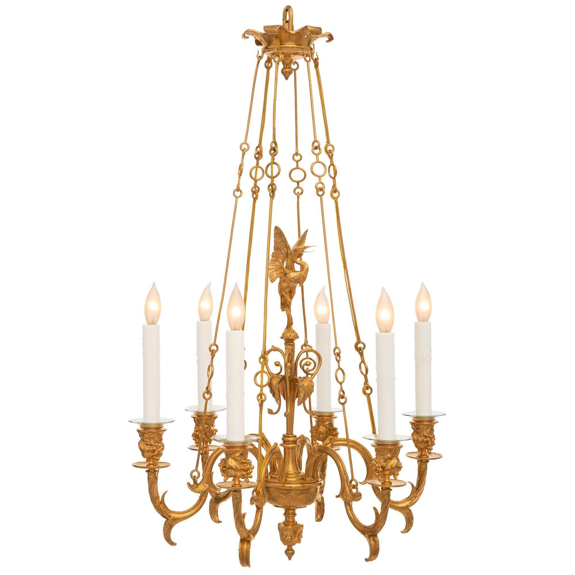 An elegant and high quality French 19th century Renaissance st. Ormolu five arm chandelier possibly by F. Barbedienne. The chandelier is centered by a most unique bottom finial with richly chased faces below beautiful interlocking palmettes designs.