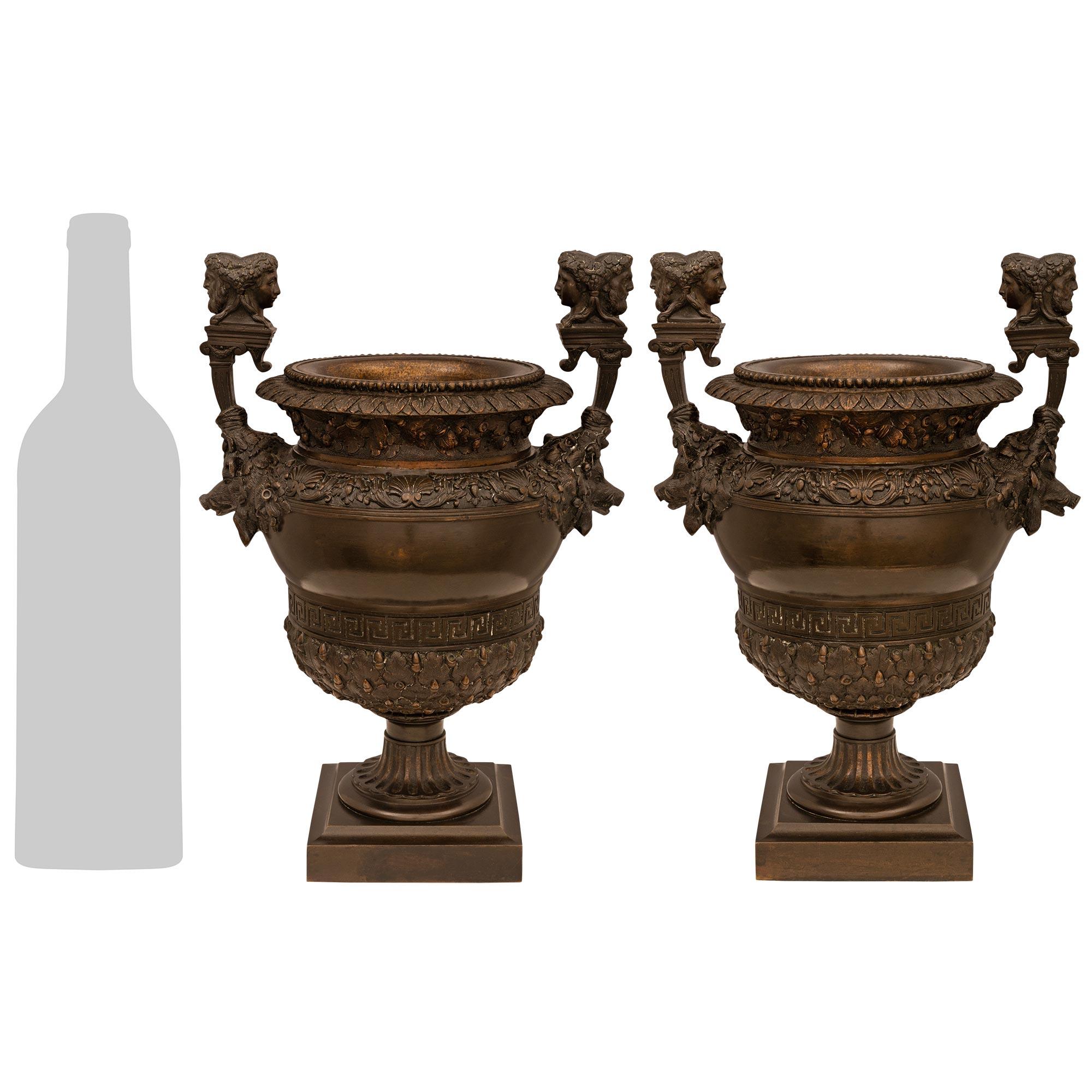 A handsome and most decorative pair of French 19th century Renaissance st. patinated Bronze urns. The urns are raised by square bases displaying the inscription 