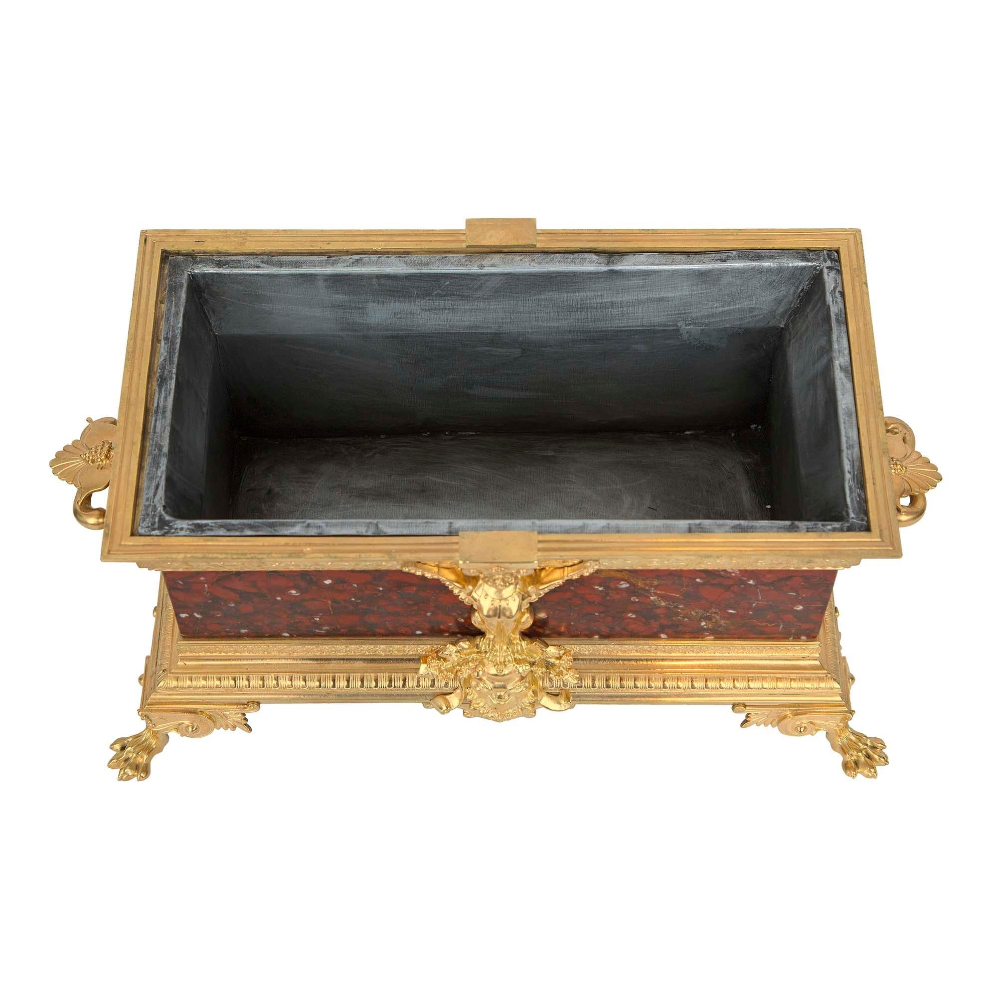 A striking French 19th century Renaissance St. Rouge Griotte marble and ormolu planter. The planter is raised by handsome ormolu paw feet below a scrolled design and palmettes with a hammered pattern. The impressive base displays fine foliate