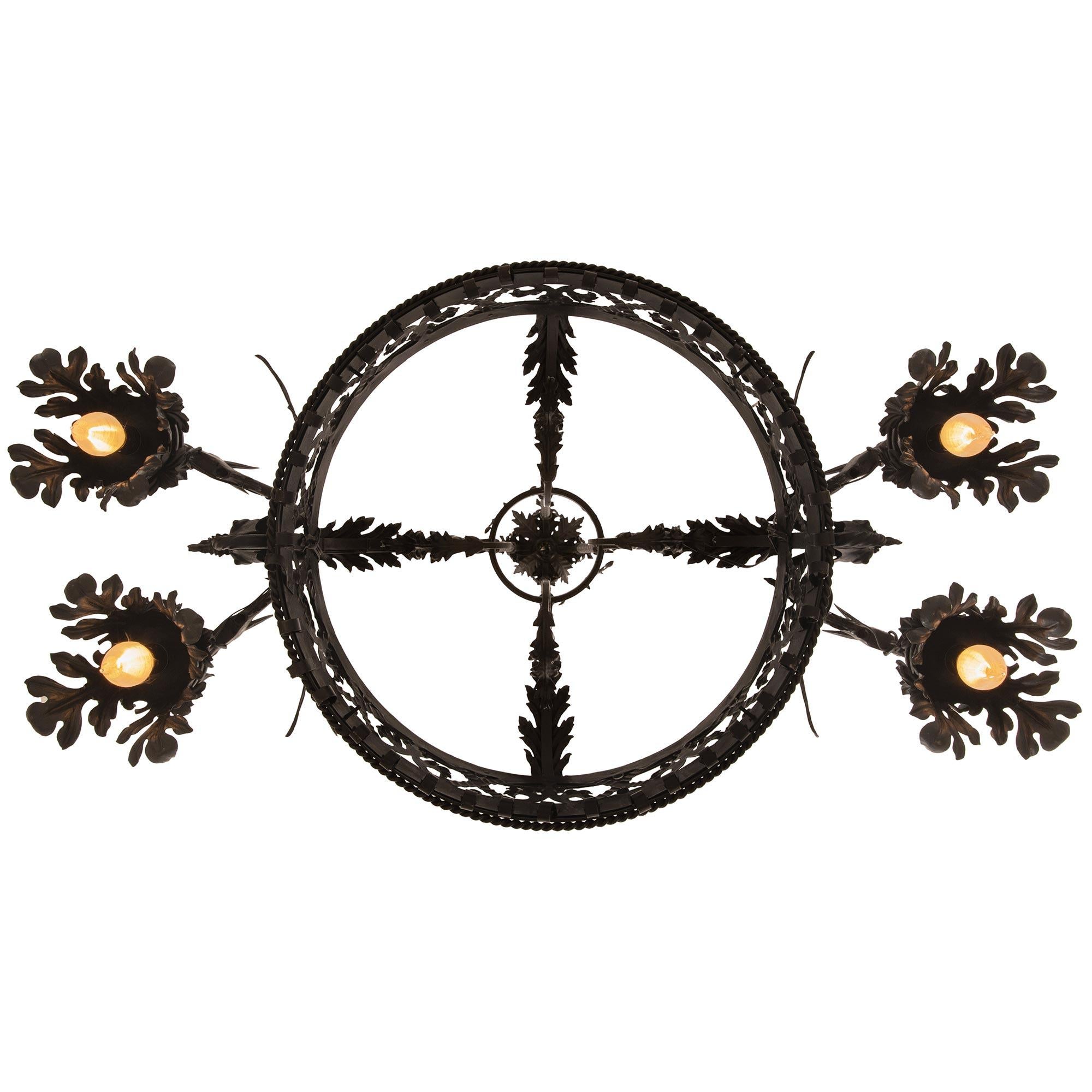 An handsome and most unique French 19th century Renaissance st. Wrought Iron chandelier. The chandelier is centered by a stunning central cage with Wrought Iron scrolls at the bottom before a smooth studded band below the pierced center displaying
