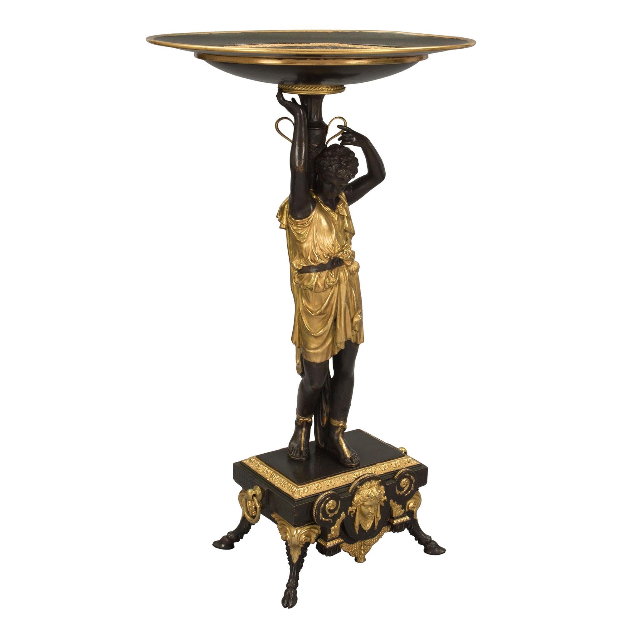 A most impressive French 19th century Renaissance style patinated bronze and ormolu side table or Vide Poche tazza. The tazza is raised by handsome patinated bronze hoof feet with ormolu acanthus leaves centering a beautiful female mask amidst