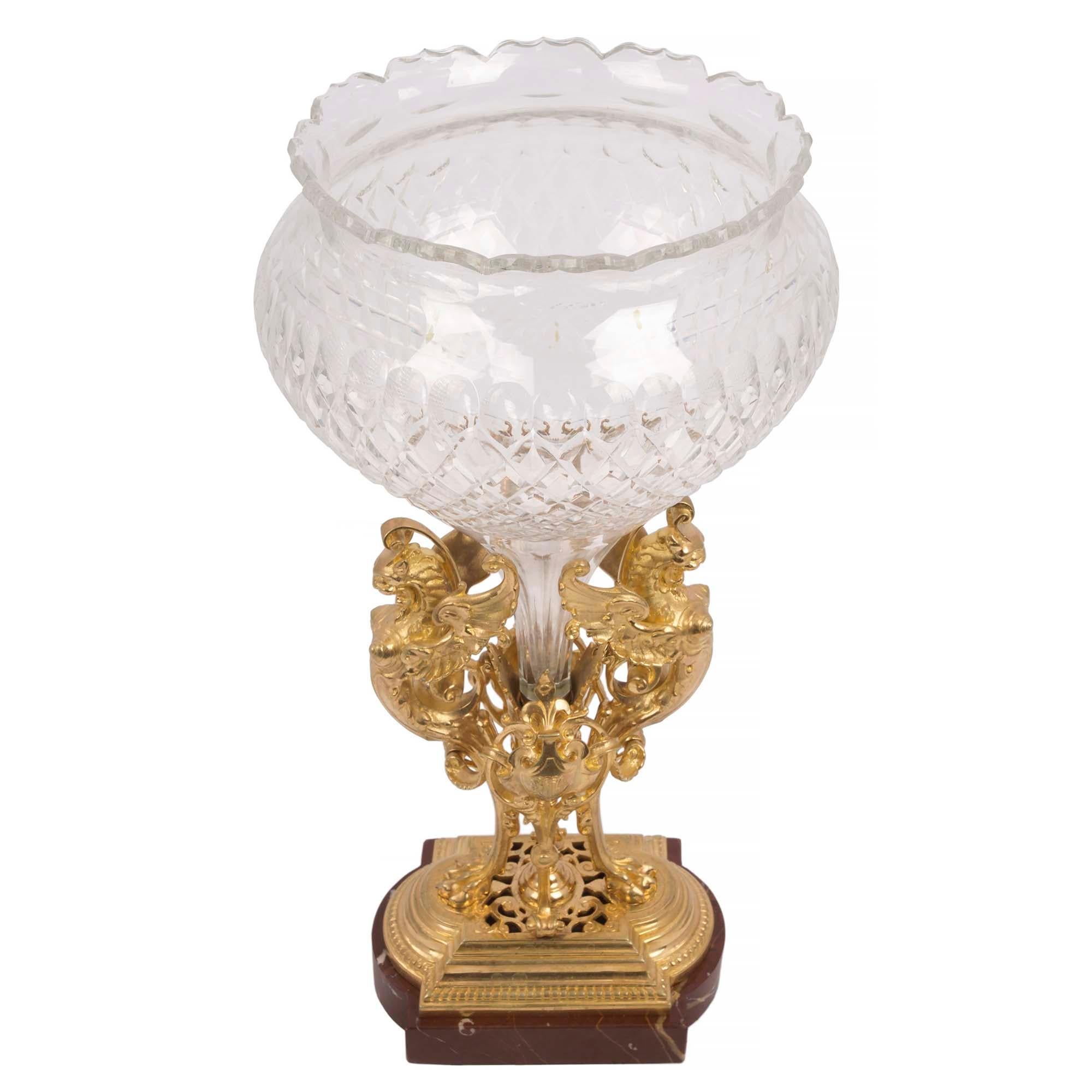 An outstanding French 19th century Renaissance st. Rouge Royale marble and Baccarat crystal centerpiece vase. The vase is raised by a rectangular Rouge Royale base with convex sides, a stepped ormolu design and fine pierced scrolled movements. The