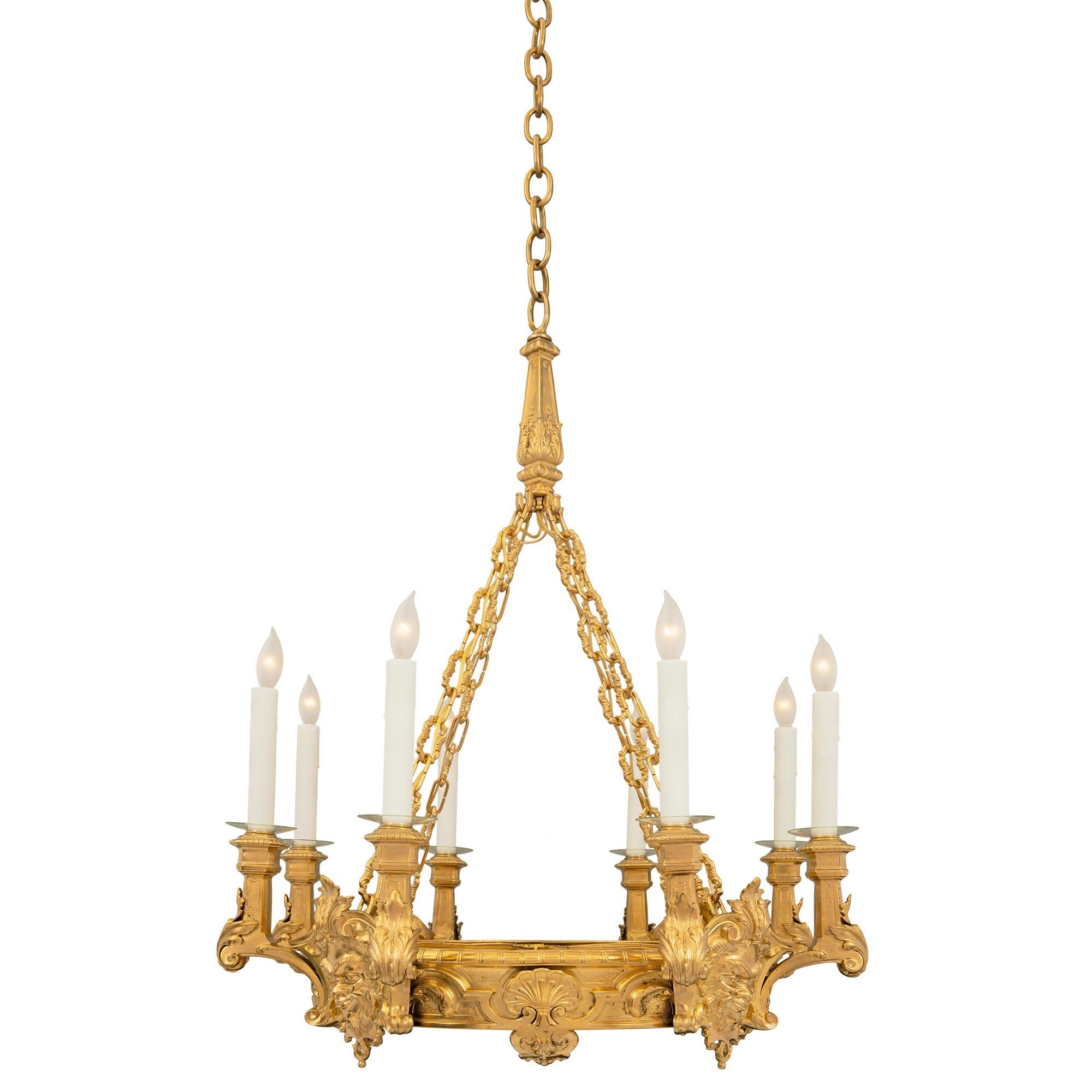 A handsome French mid 19th century Renaissance st. ormolu eight arm, twelve light chandelier. The chandelier is centered by a beautiful circular fitted onyx plateau through which the warm glow of the lighting inside can be seen. At the central tier