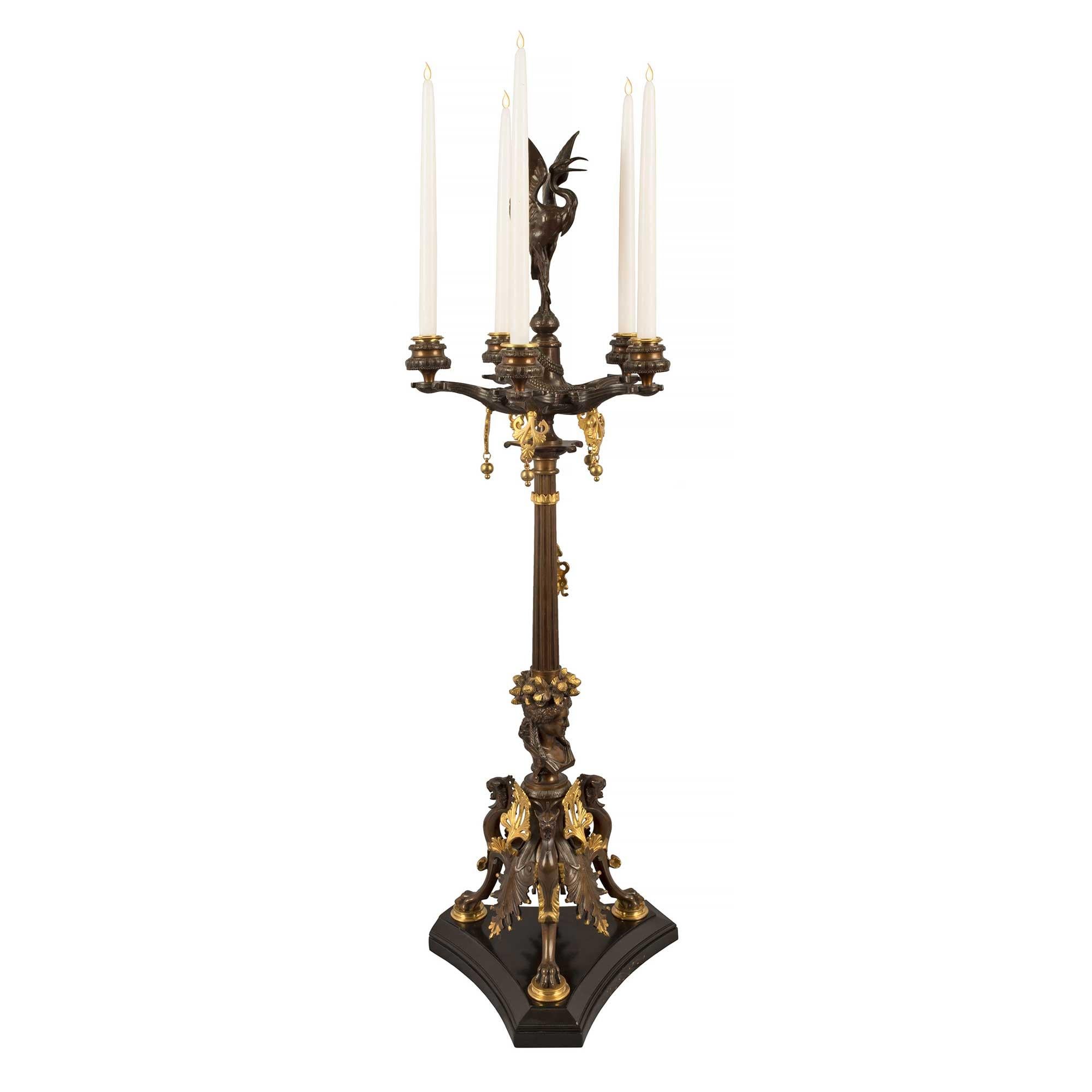 A stunning true pair of French 19th century Renaissance st. black Belgian marble, ormolu and patinated bronze, five arm candelabras, attributed to F. Barbedienne. Each candelabra is raised by a triangular black Belgian marble base with concave