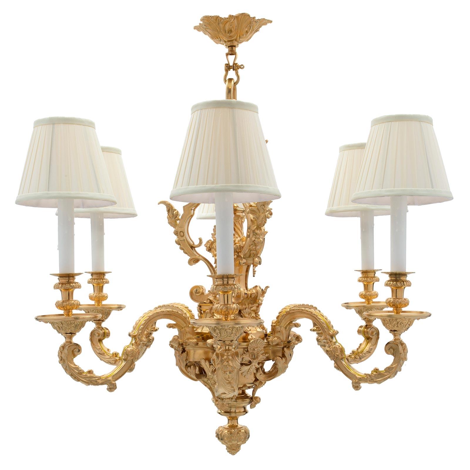A most handsome French 19th century Renaissance st. ormolu six light chandelier. The chandelier is centered by a finely chased and etched foliate finial below an elaborate and most decorative pierced and scrolled design with large foliate movements.
