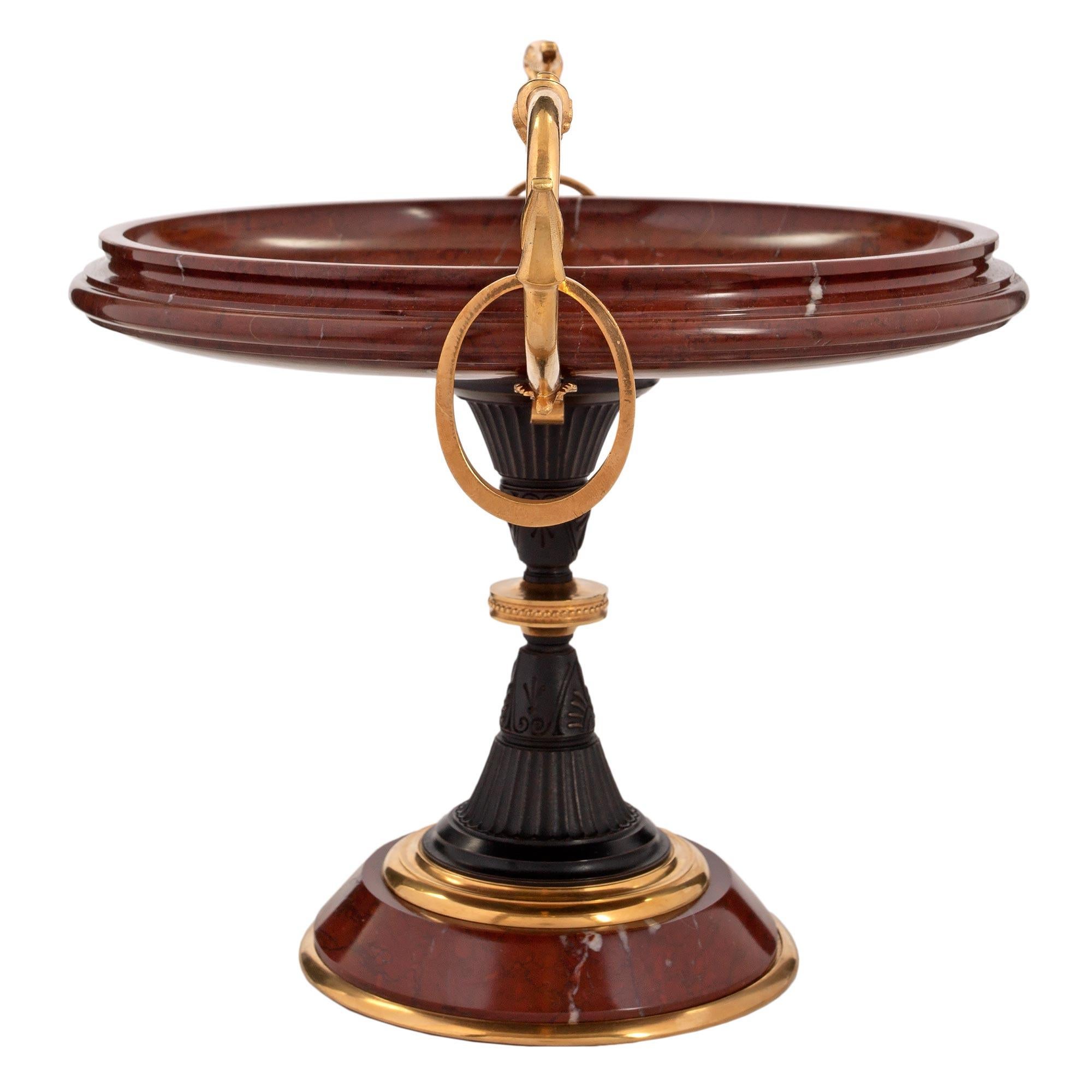 A very elegant French 19th century Renaissance st. Rouge Antique marble, ormolu and patinated bronze tazza. The tazza is raised by a circular ormolu band below the tapered marble base. The central patinated bronze support has fluted designs and