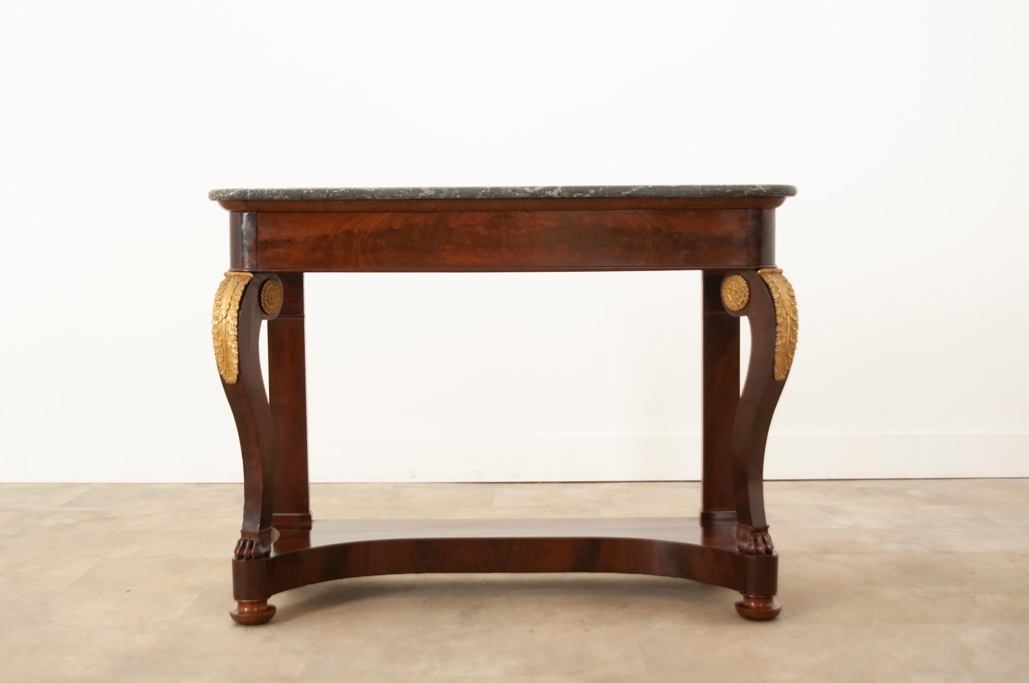 An elegant 19th century French Restauration console with its original removable piece of St Anne marble. The beautiful marble top sits over a thick shaped base, making its profile classic of the Restauration period. Thick flame mahogany veneer has