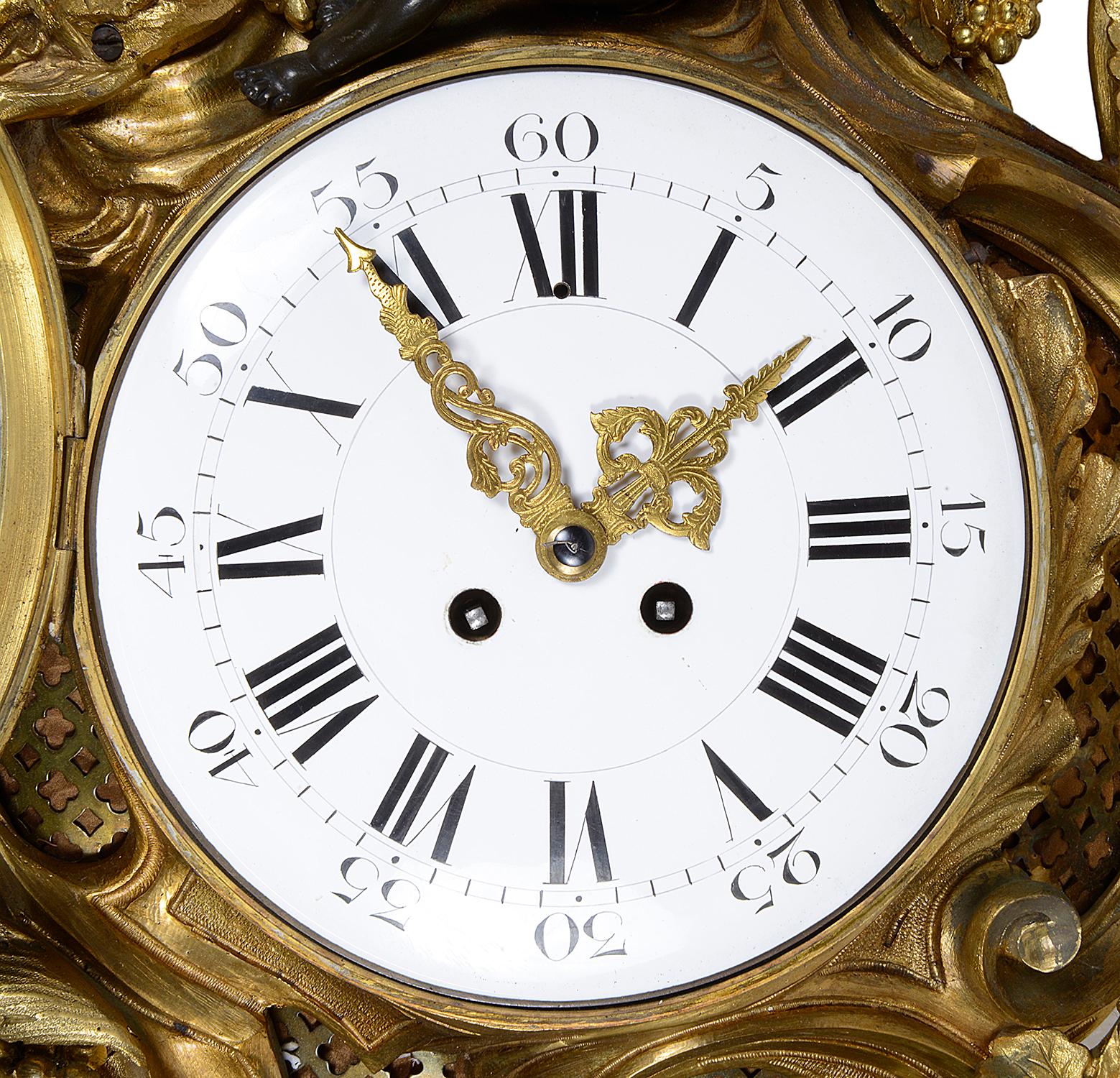 A very impressive 19th century Louis XVI style gilded ormolu and patinated bronze sun burst cartel wall clock. Depicting cherubs among clouds and sun rays. The white enamel clock face with Roman numerals, the movement having an eight-day duration
