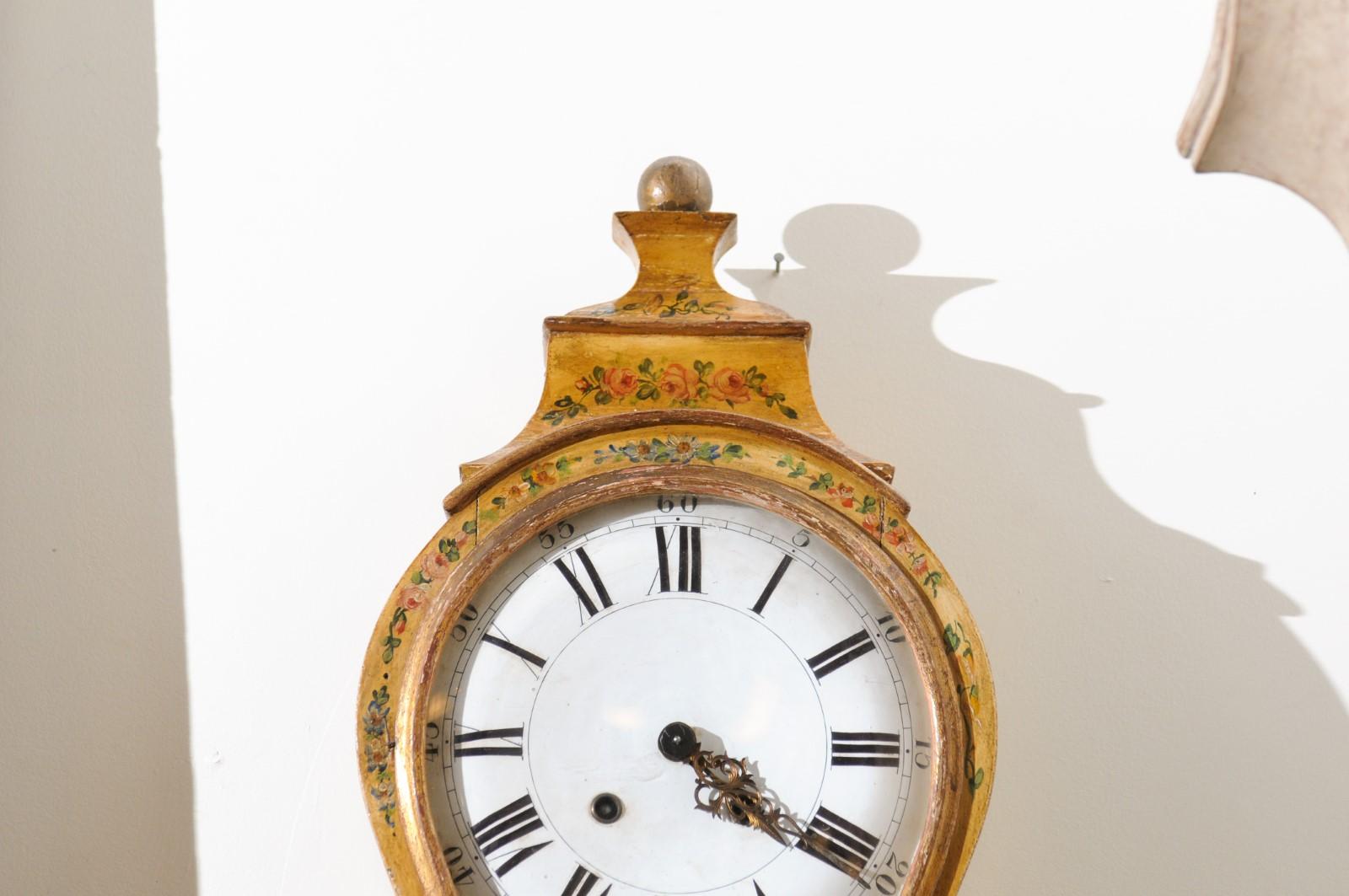 A French Rococo style three-piece tôle wall clock from the 19th century, with very rare original painted décor. Created in France during the 19th century, this tôle wall clock features a circular enameled face secured behind glass and showcasing