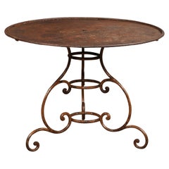 French 19th Century Round Iron Garden Table with Scrolling Base and Rusty Finish