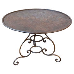 French 19th Century Round Iron Garden Table with Scrolling Base and Rusty Finish