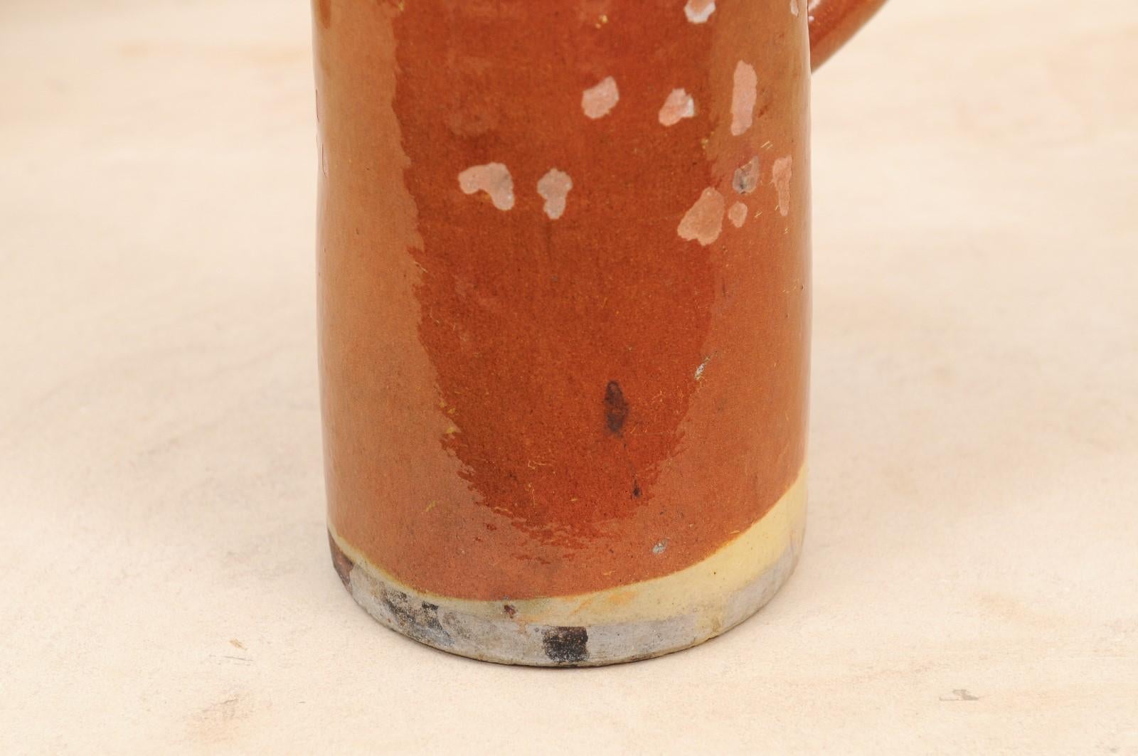 Pottery French 19th Century Rustic Pitcher with Rust Colored Glaze and Straight Handle For Sale