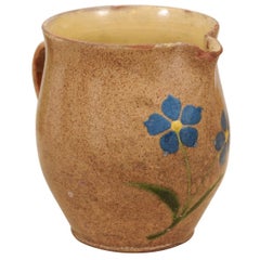 French 19th Century Rustic Pottery Pitcher with Mustard Glaze and Blue Flowers